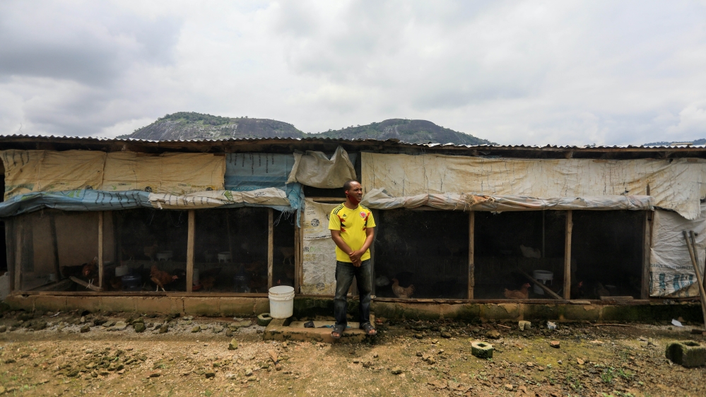 A farmer stands in front of his poultry farm in Kubwa Abuja, Nigeria
