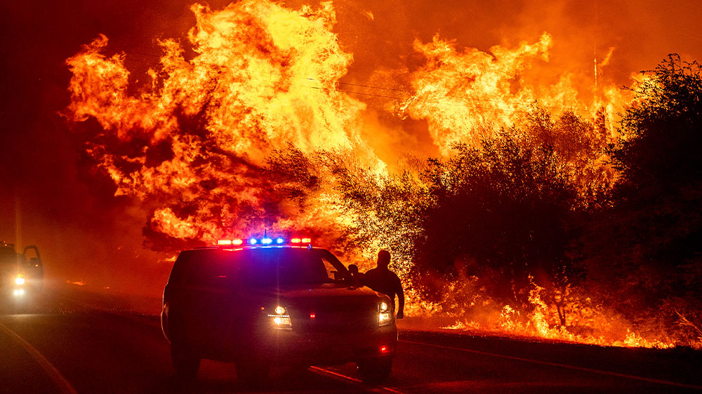 Flames bear down on vehicles on Highway 162 in Oroville, north of Sacramento in California on September 9
