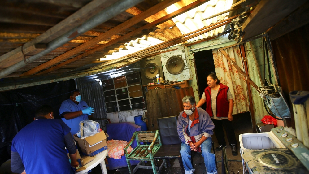 A couple wait to be tested for the coronavirus disease inside their house, in Xochimilco, one of the highly contagious zones, on the outskirts of Mexico City, Mexico