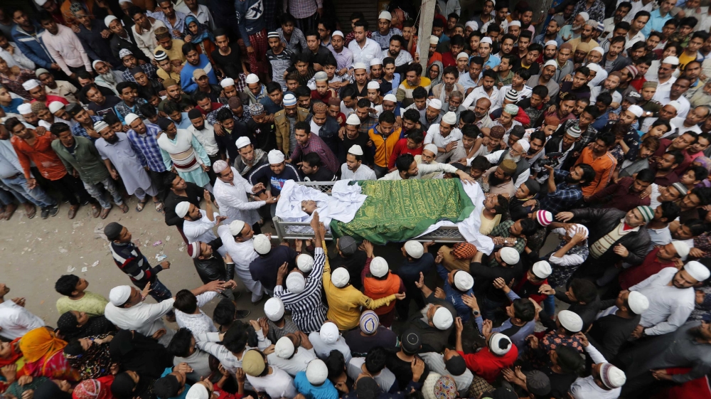 People carry the body of Hashim Ali, who was wounded on Tuesday in a clash between people demonstrating for and against