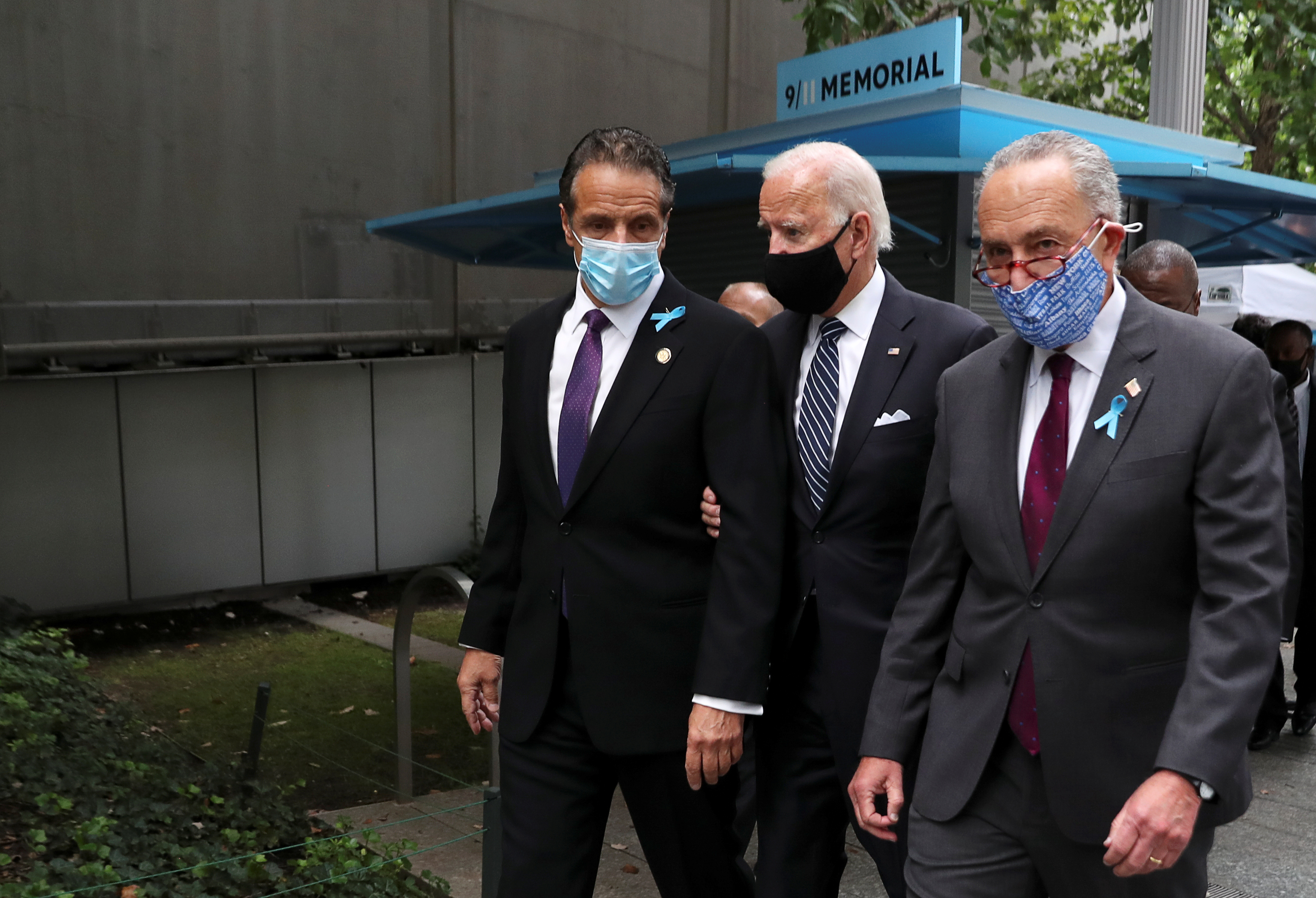 Democratic presidential nominee Joe Biden walks next to US Senate Minority Leader Chuck Schumer (D-NY) and New York Governor Andrew Cuomo wearing face masks, on the 19th anniversary of the September 11, 2001 attacks on the World Trade Center at the 9/11 Memorial & Museum in the Manhattan borough of New York City