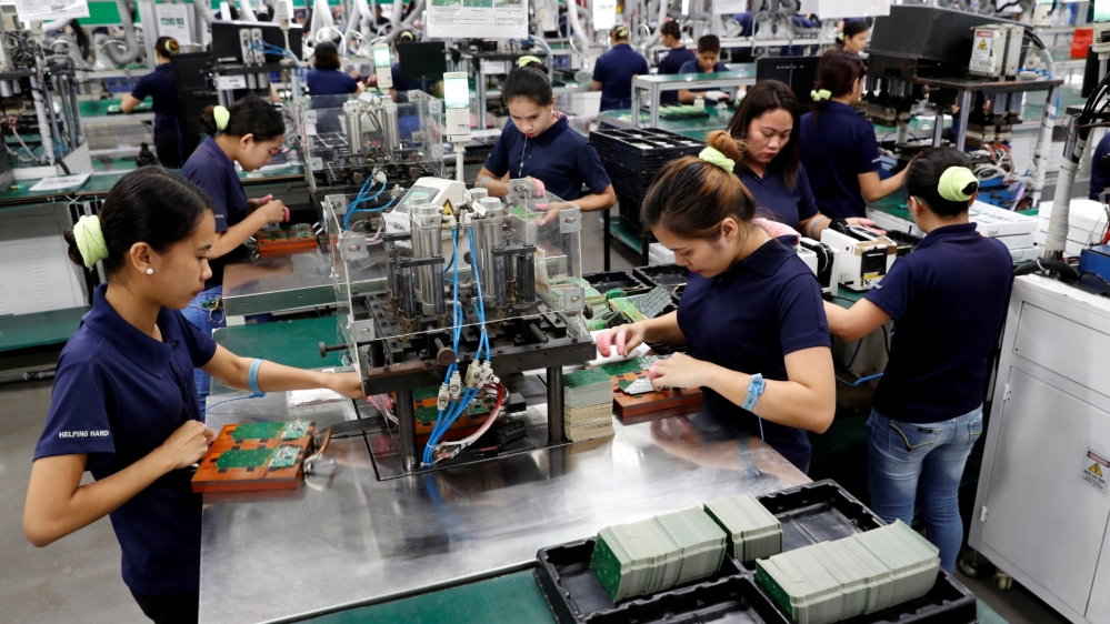 Filipinos work at the assembly line of Kinpo Electronics factory in Malvar