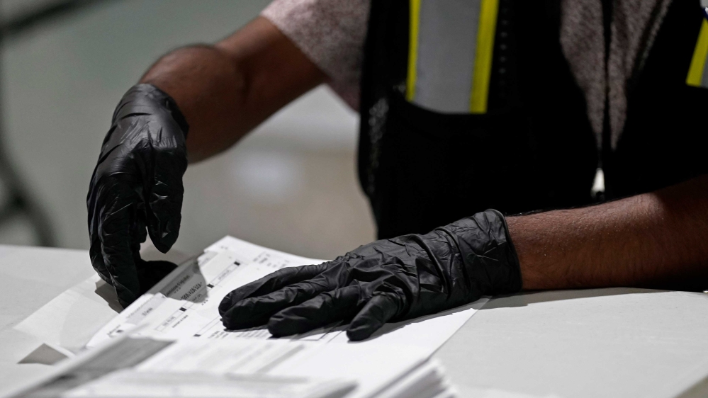A worker prepares absentee ballots for mailing at the Wake County Board of Elections in Raleigh, North Carolina