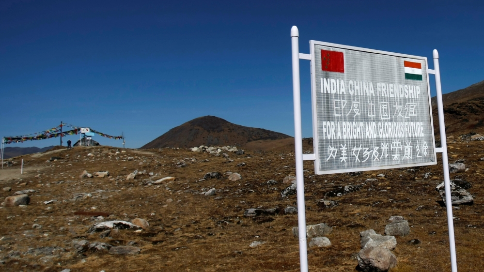 A signboard is seen from the Indian side of the Indo-China border at Bumla, in the northeastern Indian state of Arunachal Pradesh, November 11, 2009. REUTERS/Adnan Abidi/File Photo