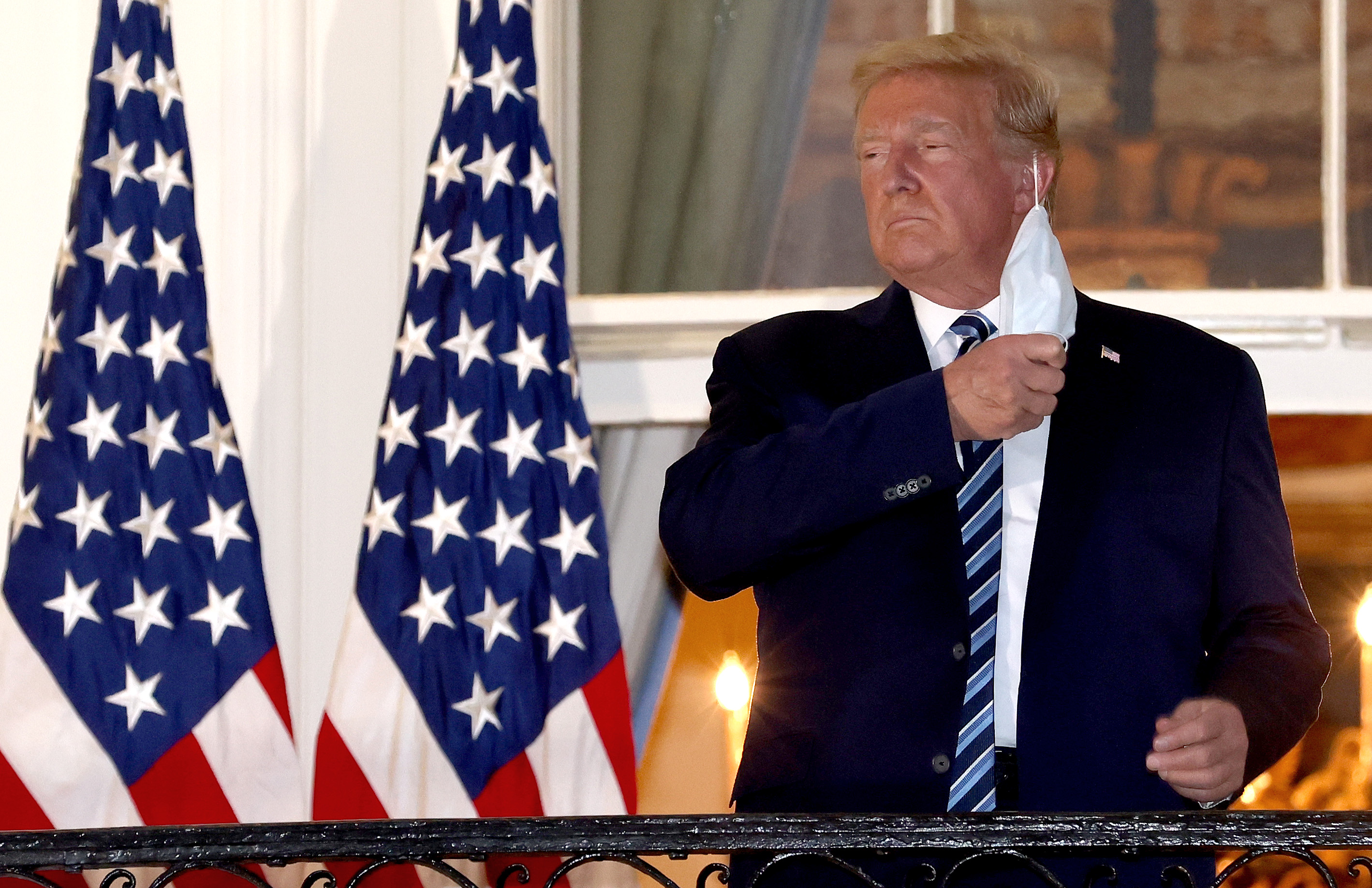 Donald Trump removes his face mask