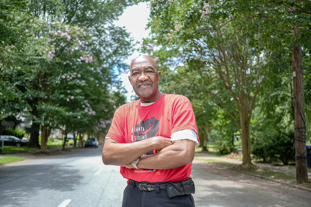 Robert Darden in Peoplestown with crepe myrtles blooming behind him