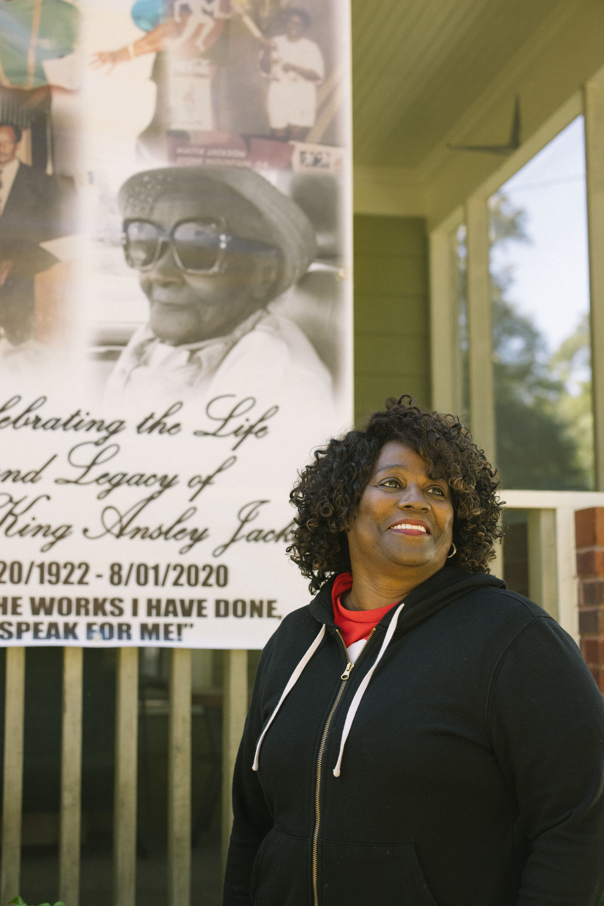 Sheryl Calhoun, Mattie Jackson’s daughter, stands outside her late mother’s house. Jackson’s commitment to community activism began when she was just 14 and last until her death at age 98 in August