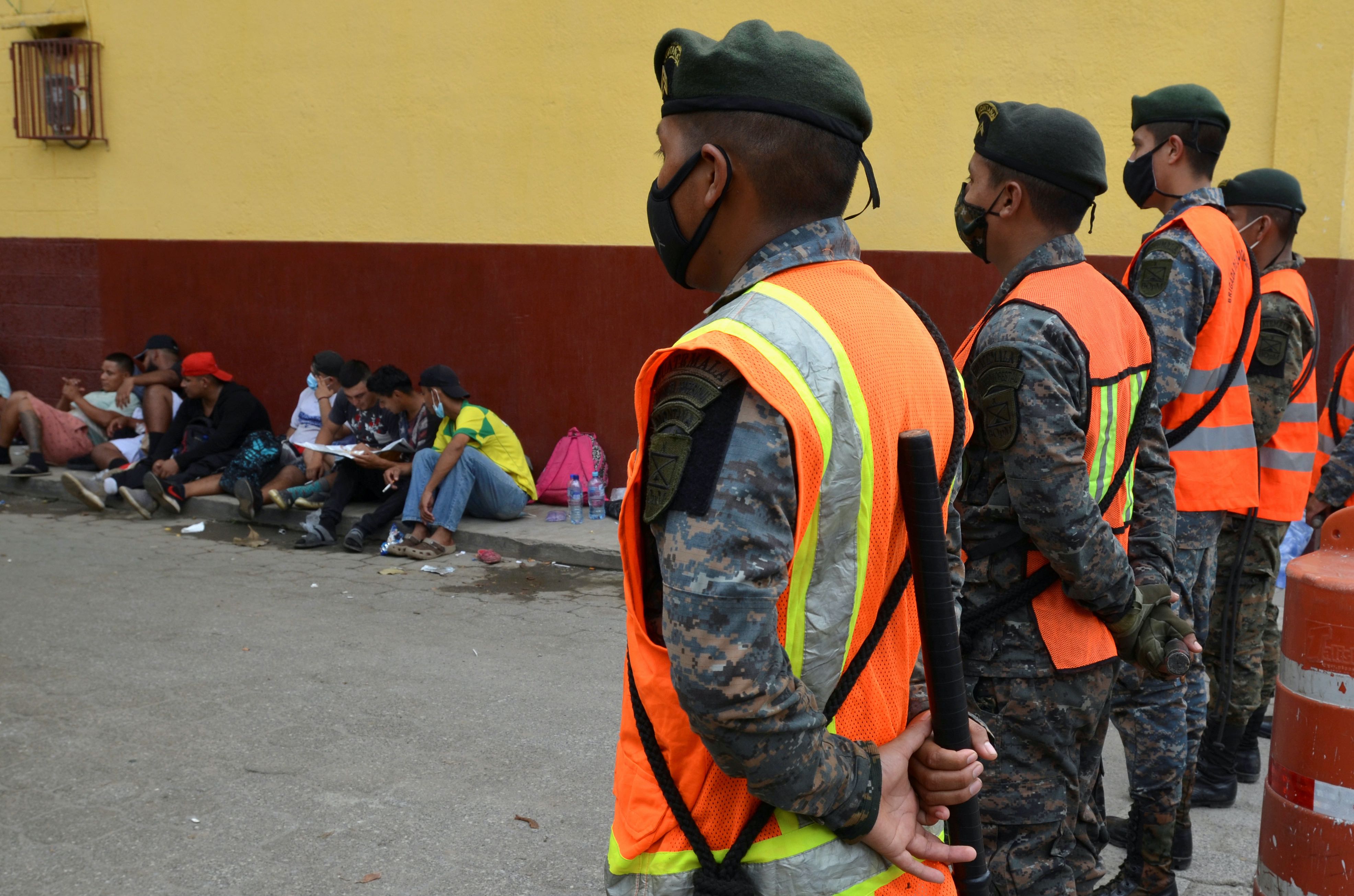 Guatemalan soldiers form a line to prevent a group of Honduran migrants who are trying to reach the United States from moving towards the Guatemala and Mexico border in Tecun Uman, Guatemala