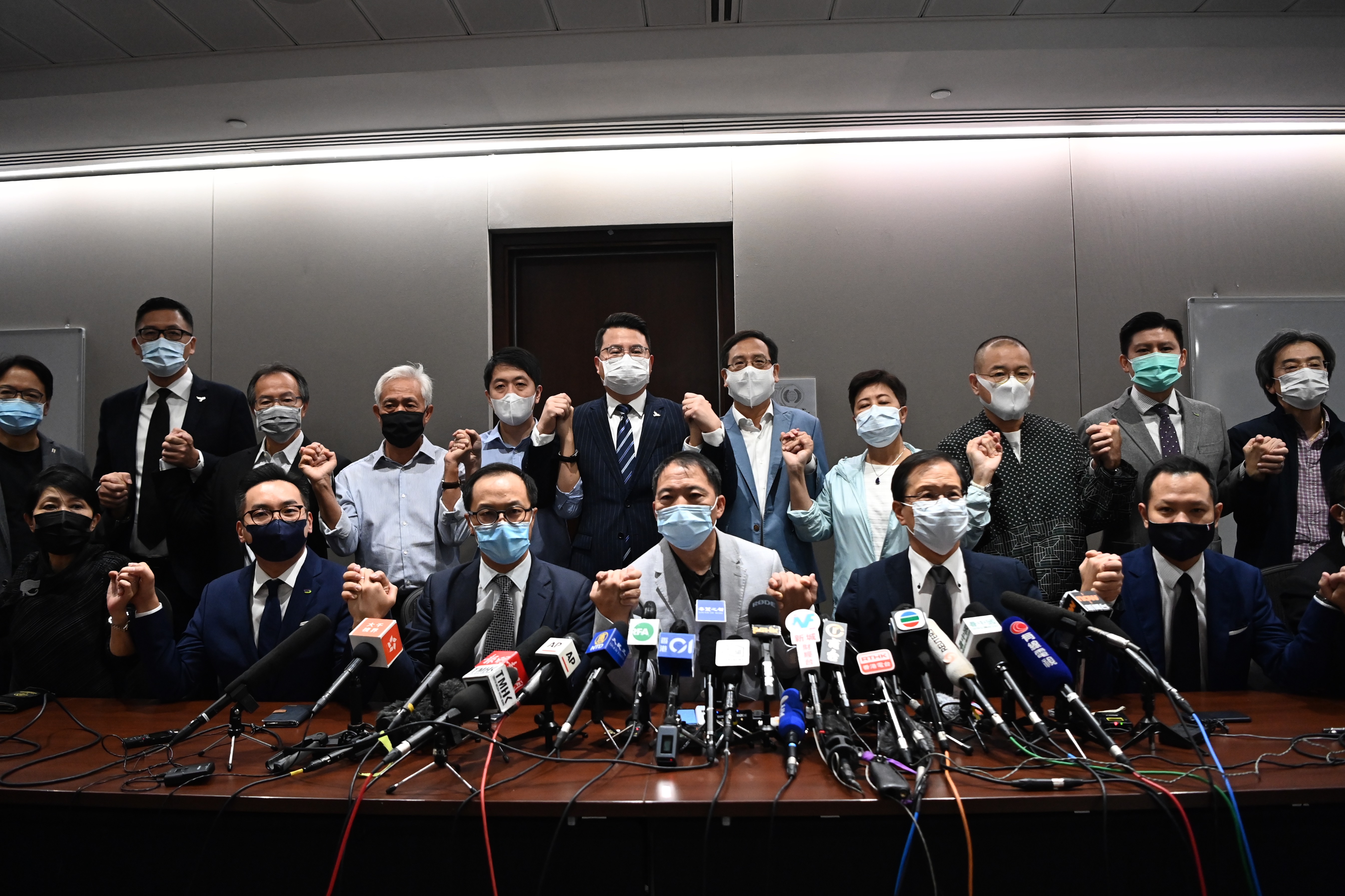 Pro-democracy legislators announced they would resign en masse after the government disqualified four of their colleagues claiming they were a threat to national security