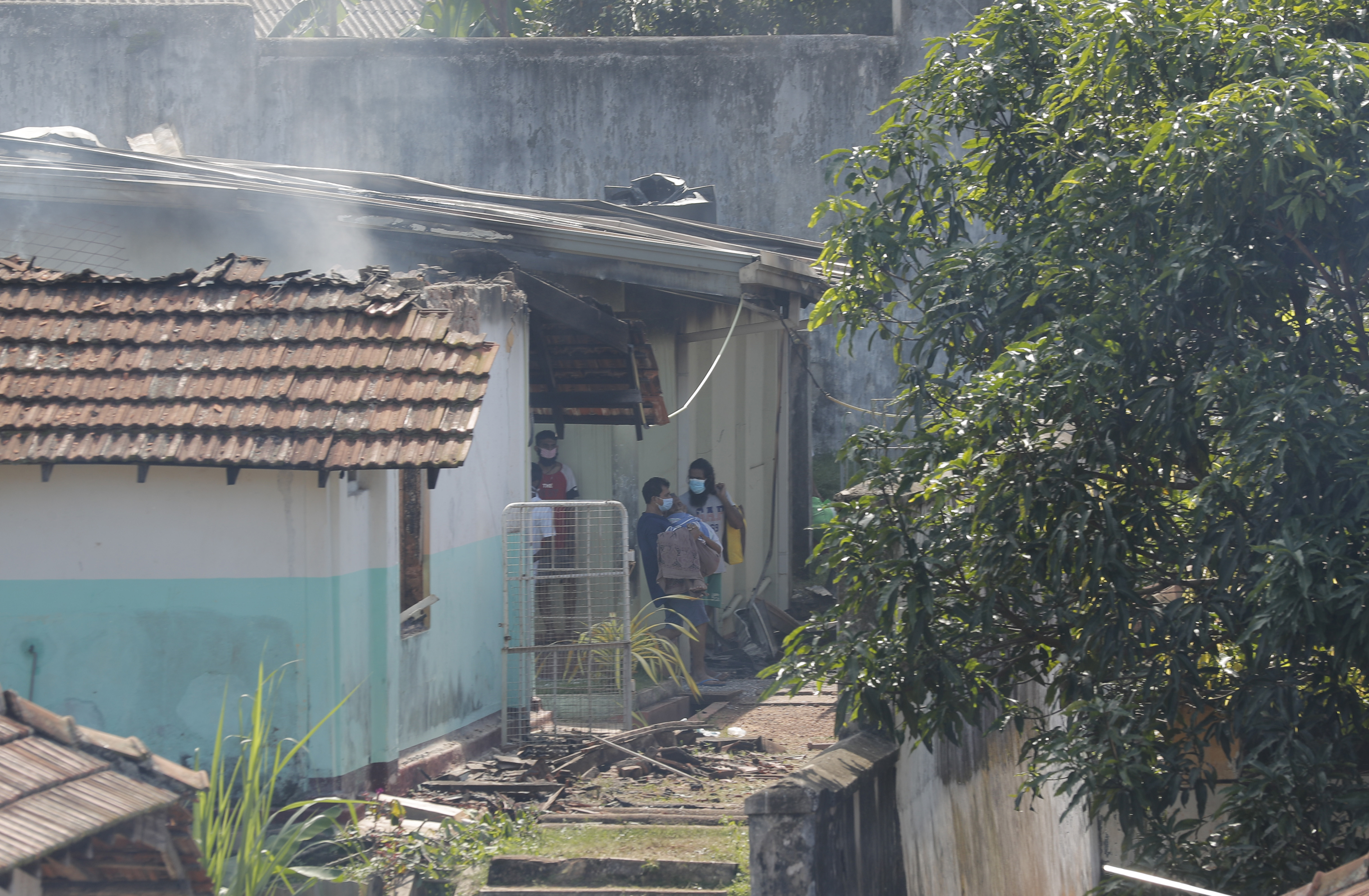 Inmates fought with guards on Sunday and into the night after setting fire to the kitchens and briefly took two warders hostage