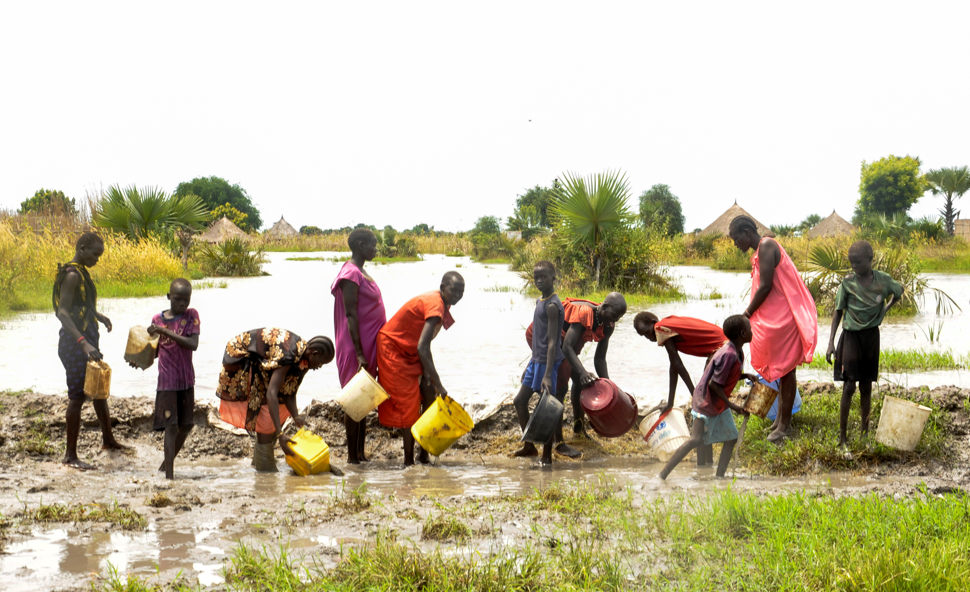 Civilians attempt to block floodwater from the broken dykes on the Nile River, in Unity State, South Sudan