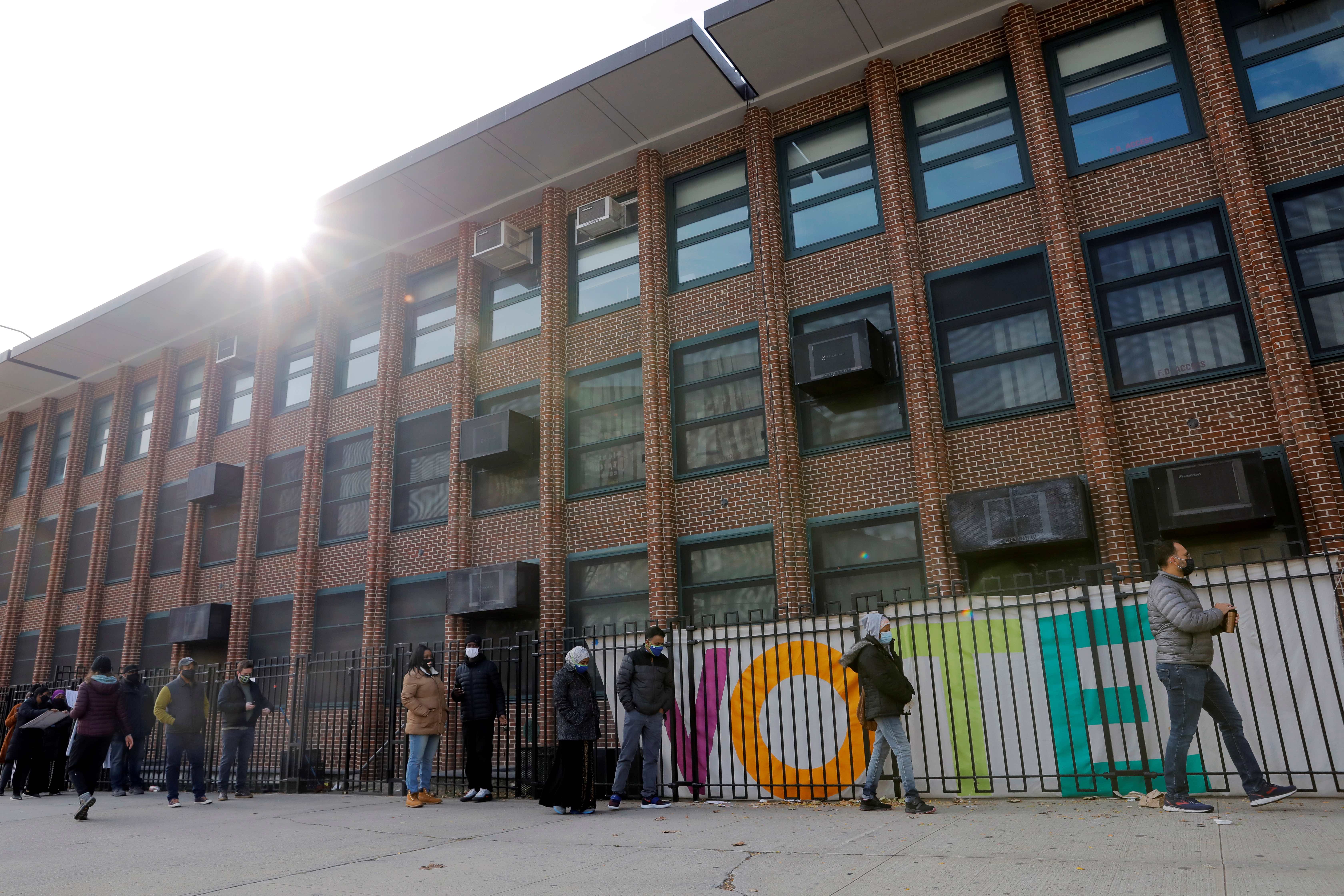 People line up to vote at the James Weldon Johnson School on election day in Harlem in the Manhattan borough of New York City, New York, United States