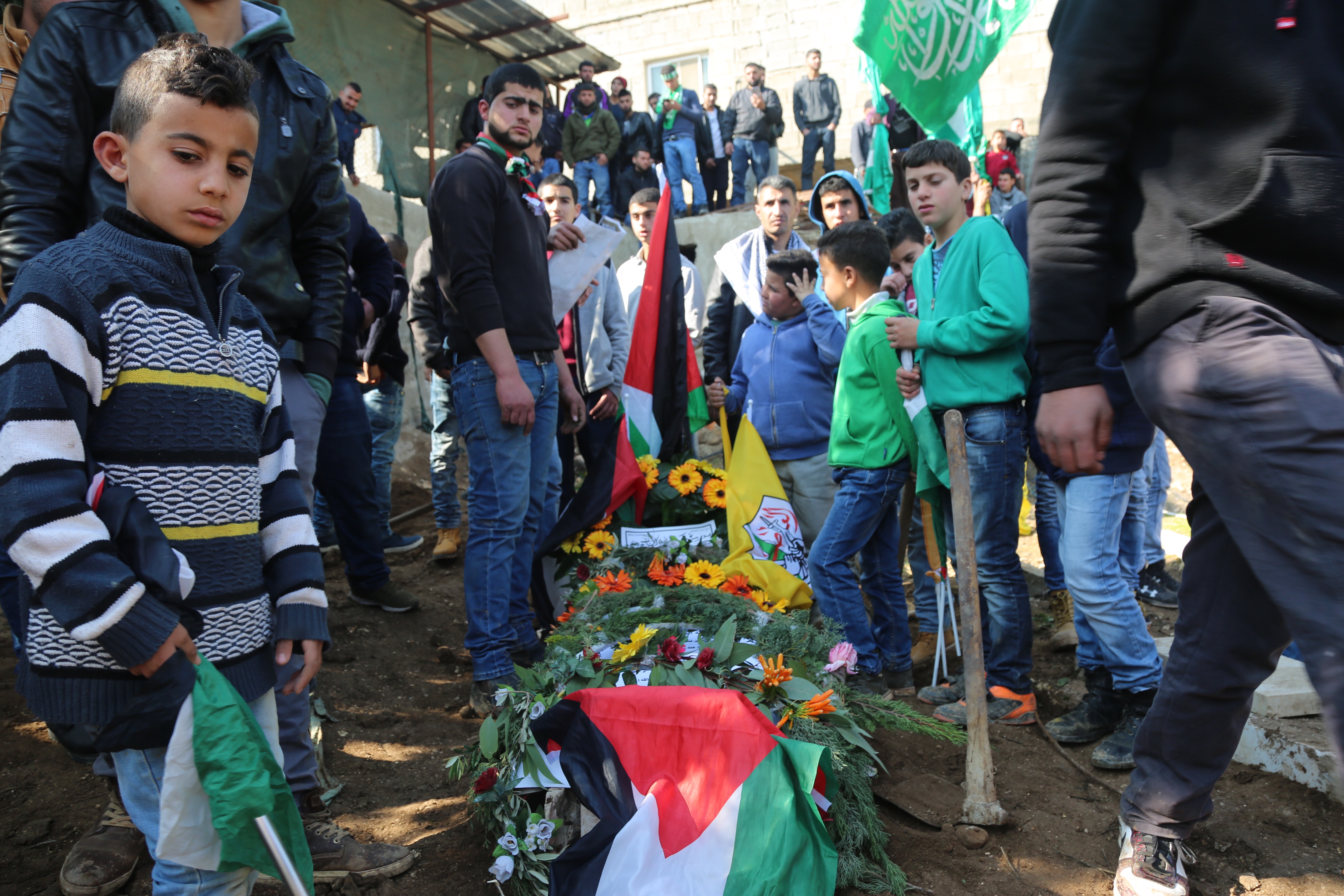 Palestinians attend the funeral of 16-year-old Laith Abu Naim in al-Mughayyir, occupied West Bank in 2018
