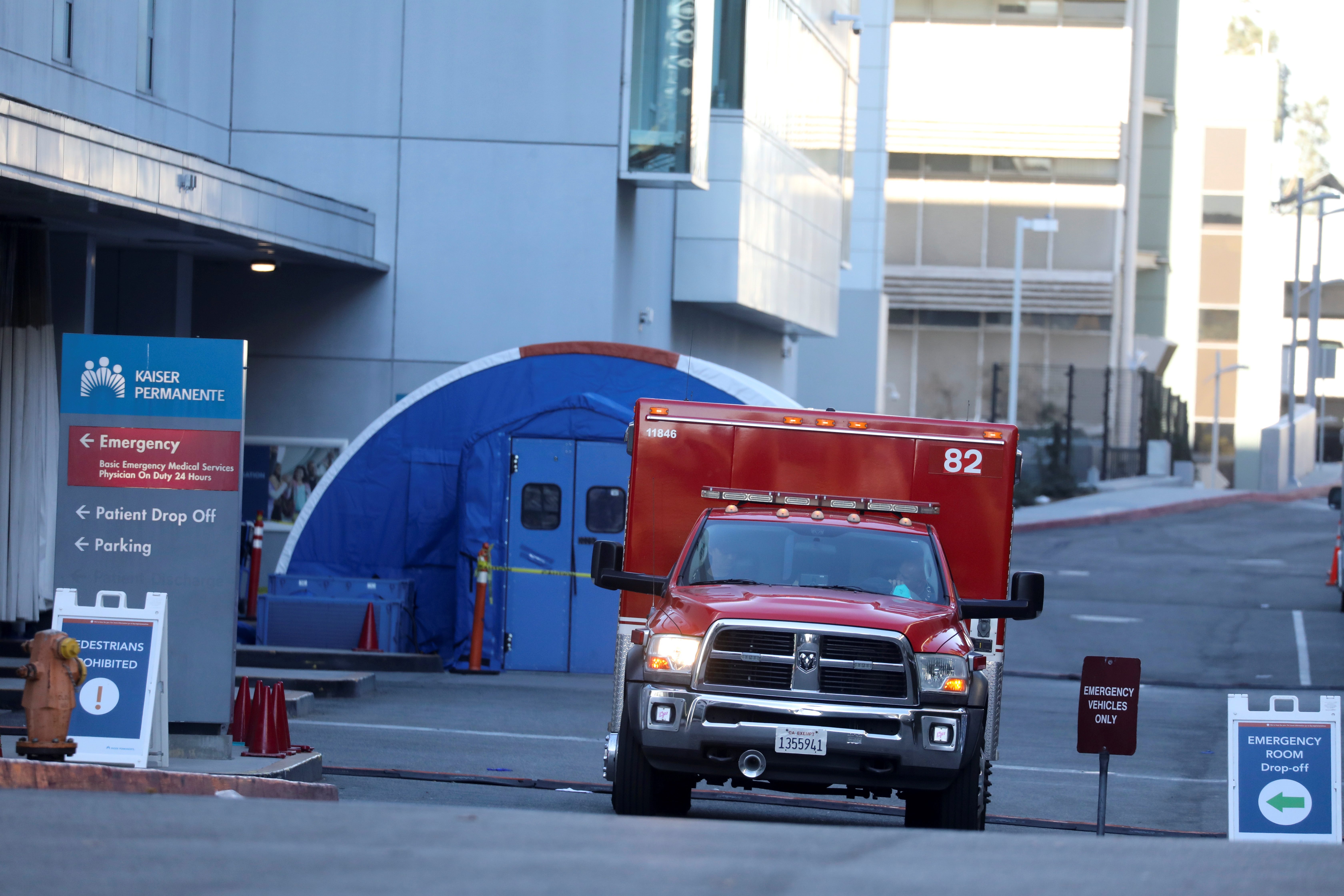 An ambulance crew leaves the Kaiser Permanente Hospital emergency room during a surge of coronavirus cases in Los Angeles