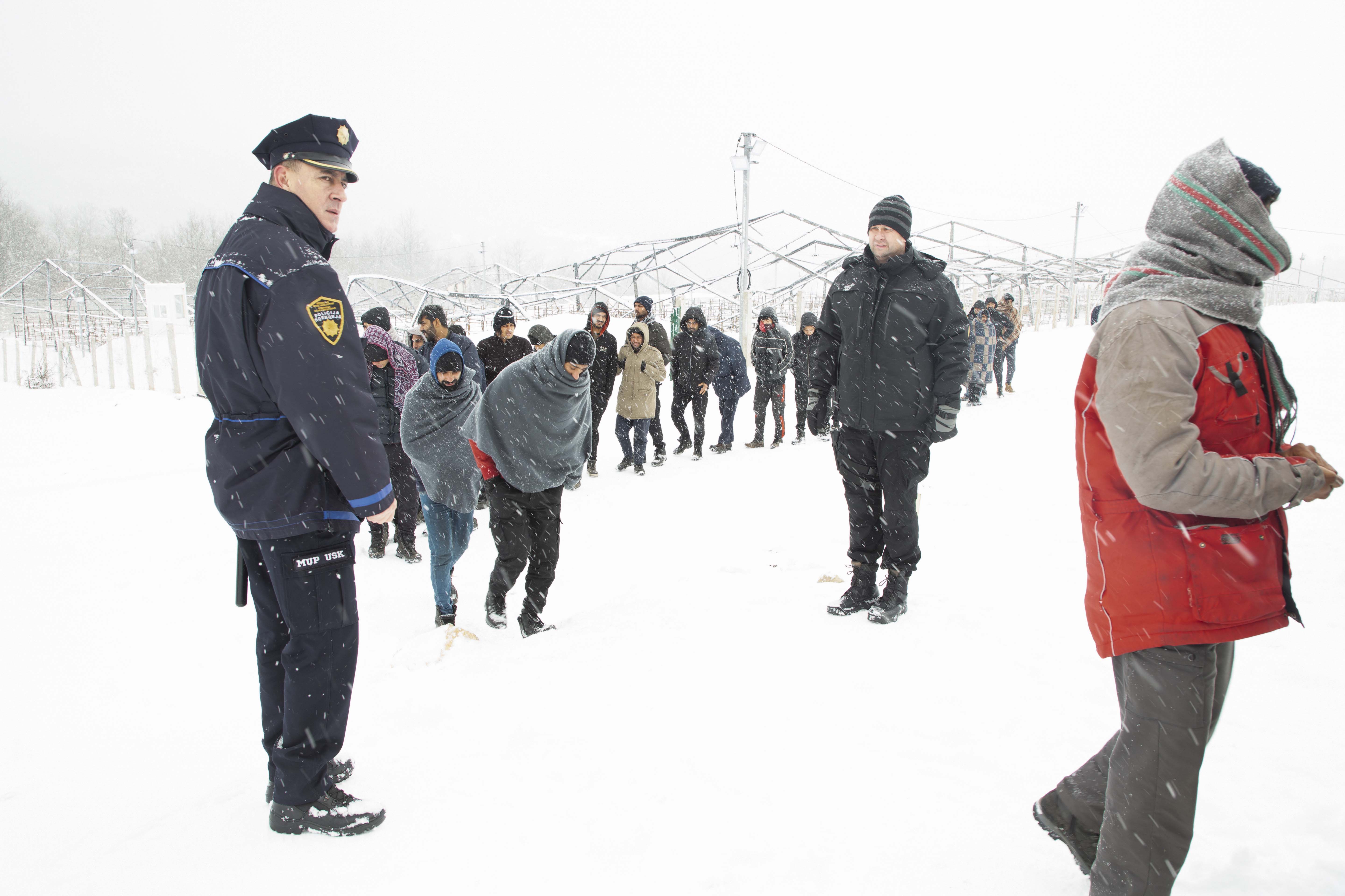People wait in line for food in Lipa, Bihac, Bosnia