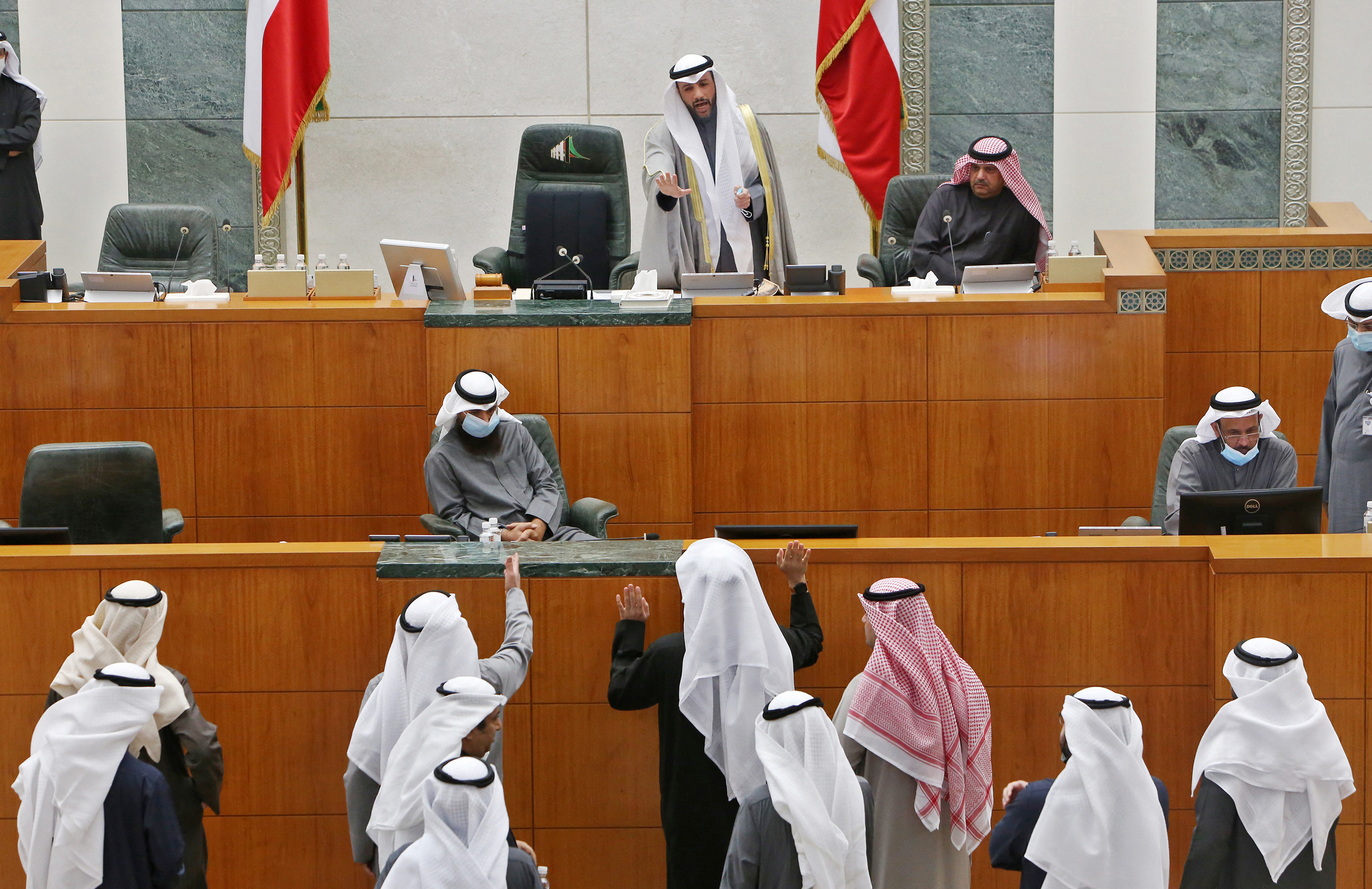 Kuwaiti MPs speak with parliament speaker Marzouq al-Ghanim