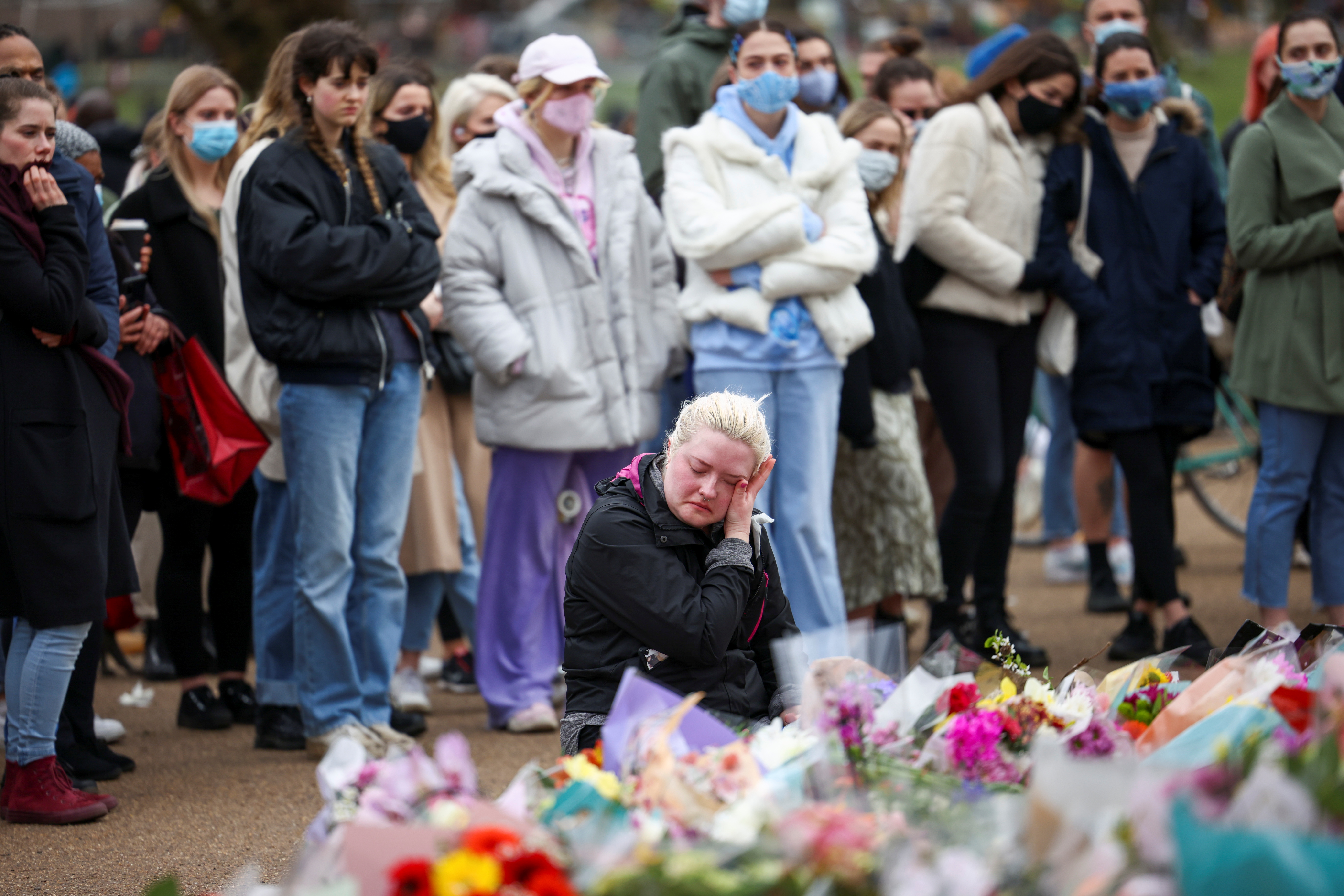 People mourn at a memorial site at the Clapham Common Bandstand, following the kidnap and murder of Sarah Everard