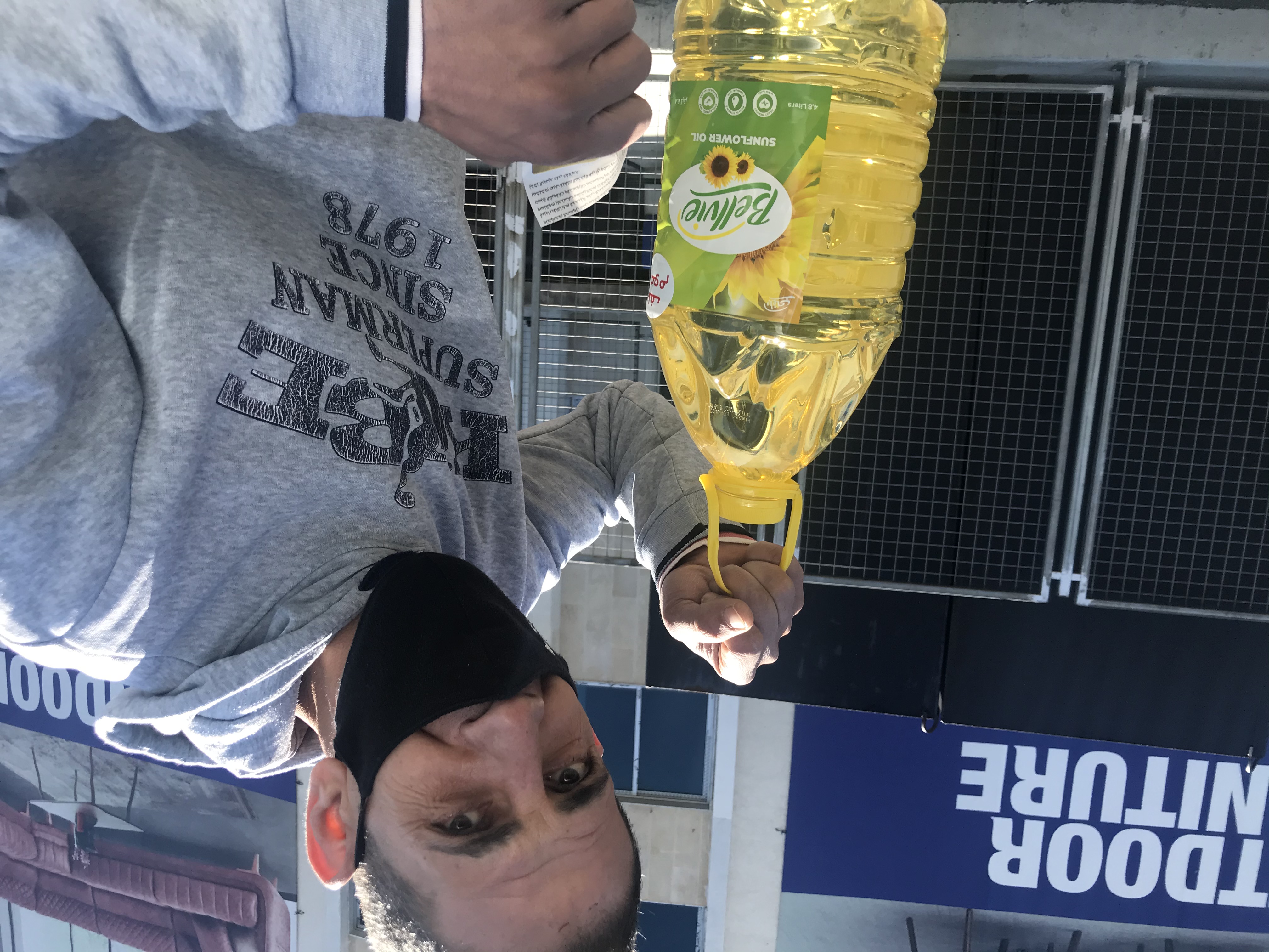A man with cooking oil was outside a supermarket in Batroun, after a quarrel over who gets to purchase the product