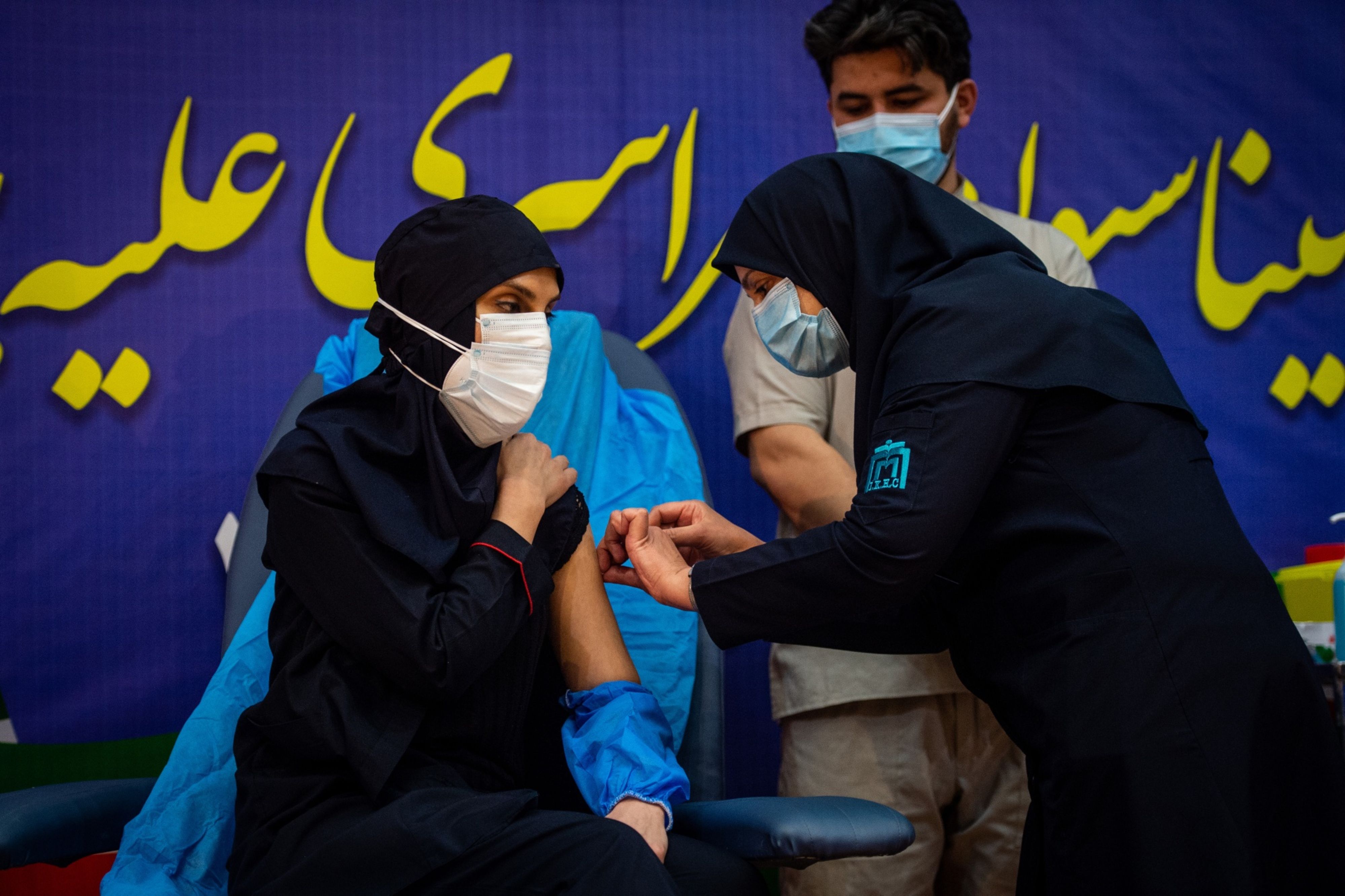 A medical worker administers a dose of Russia’s Sputnik V vaccine at the Imam Khomeini hospital in Tehran