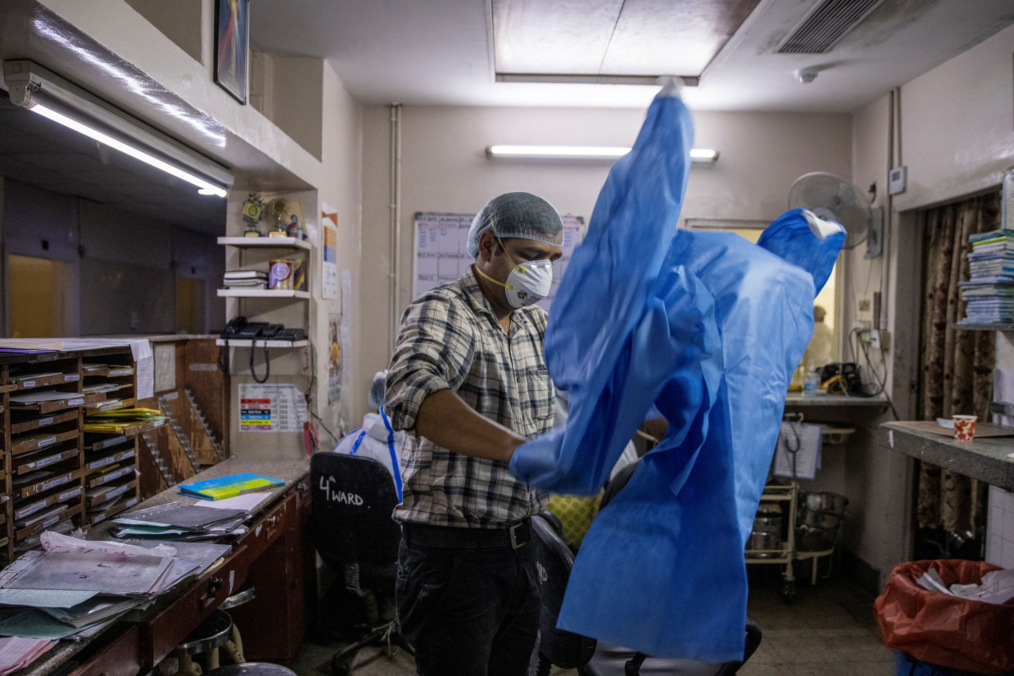 Rohan Aggarwal puts on personal protective equipment