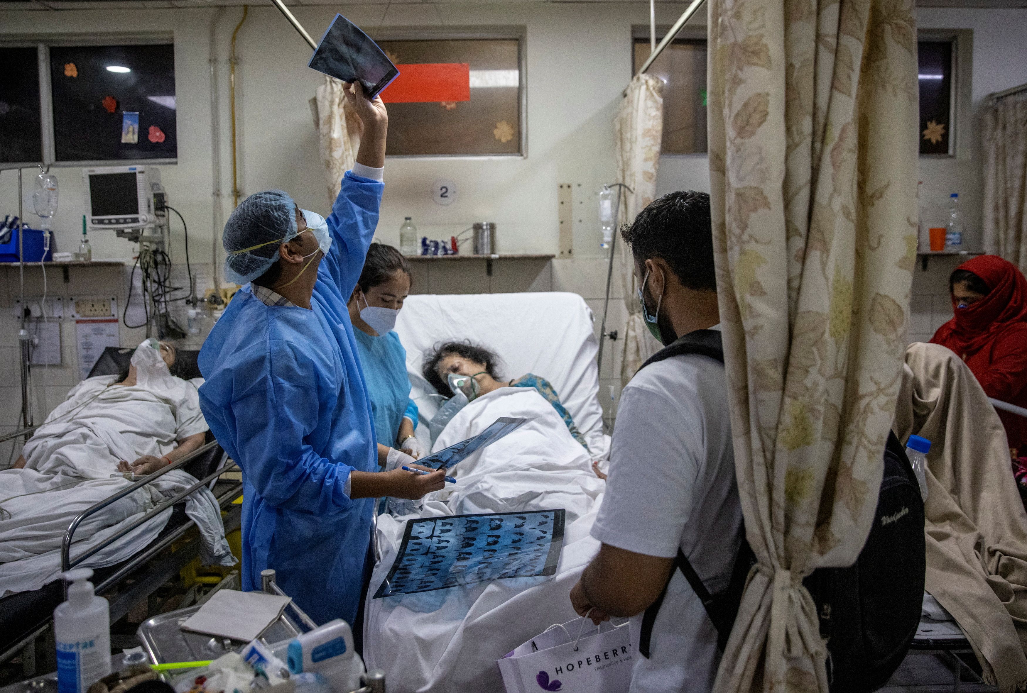 Rohan Aggarwal looks at a patient’s x-ray scan inside the emergency room of Holy Family Hospital in New Delhi