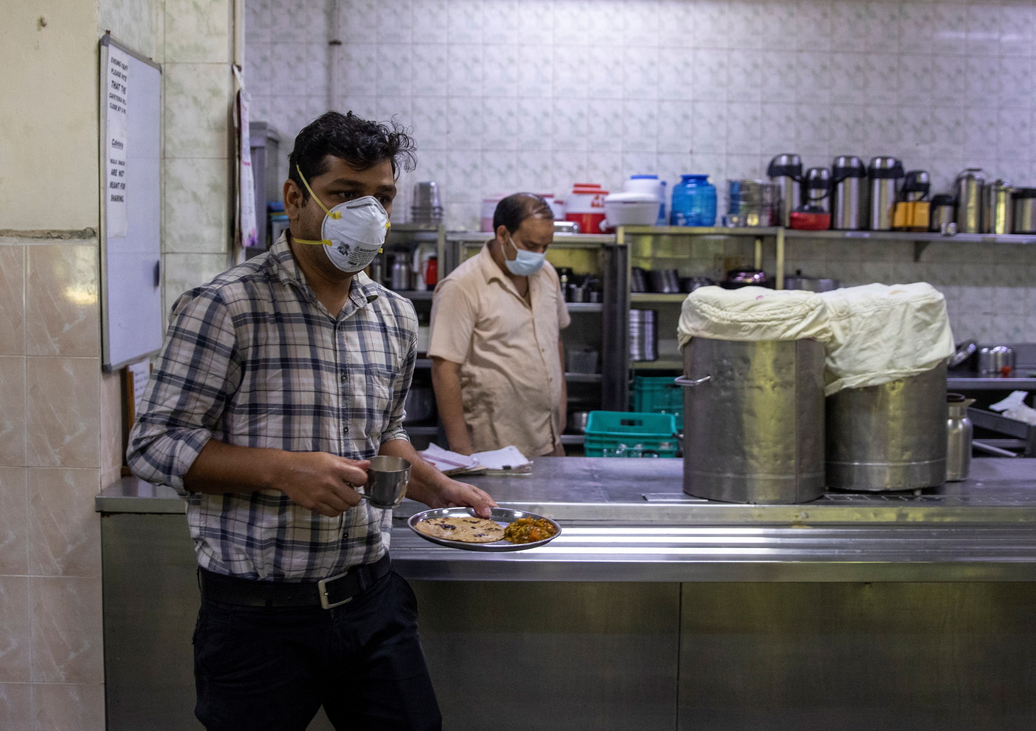 Rohan has breakfast inside the canteen during his 27-hour shift at Holy Family Hospital in New Delhi
