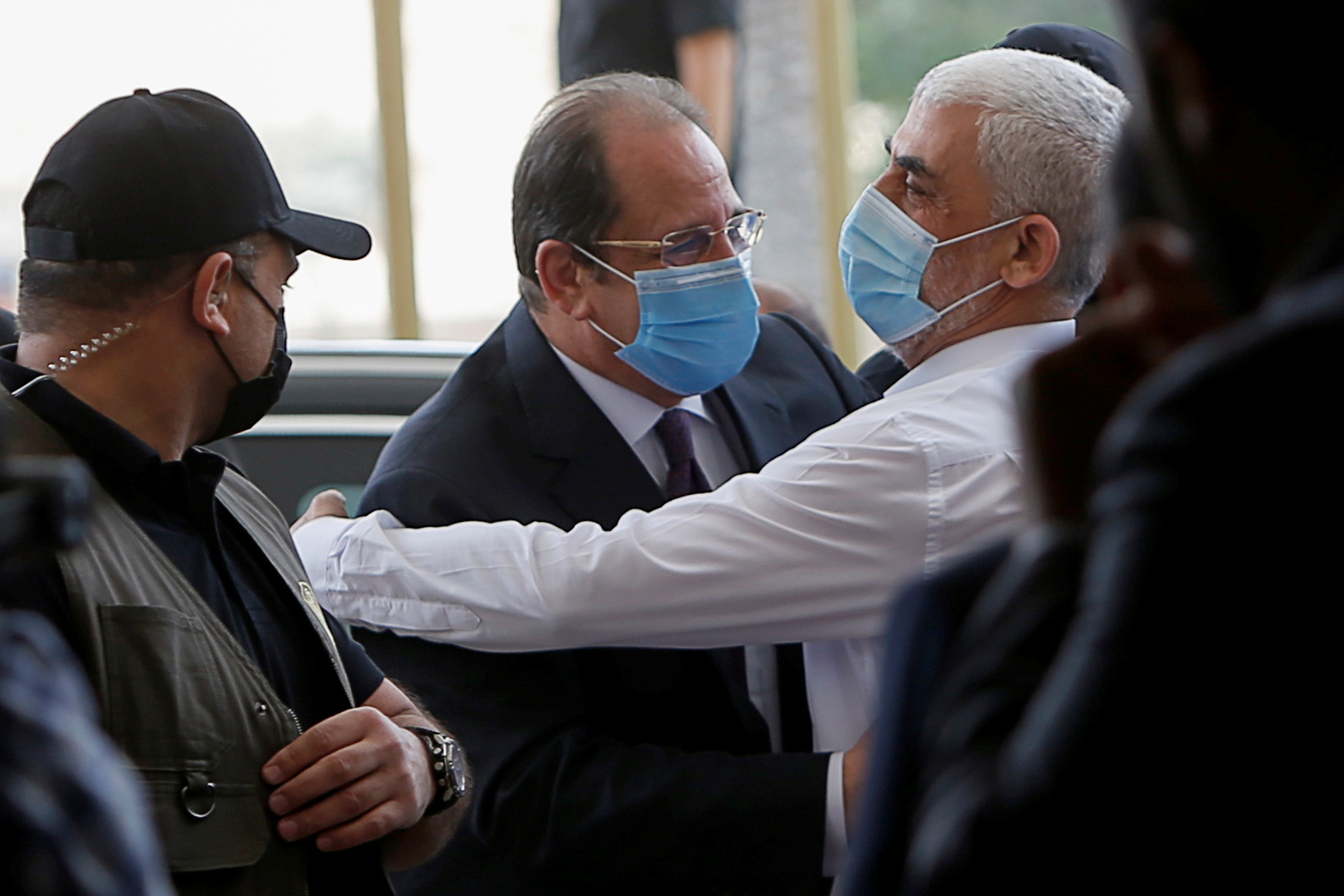 Palestinian Hamas Gaza chief Yehya al-Sinwar hugs the head of the Egyptian general intelligence, Abbas Kamel