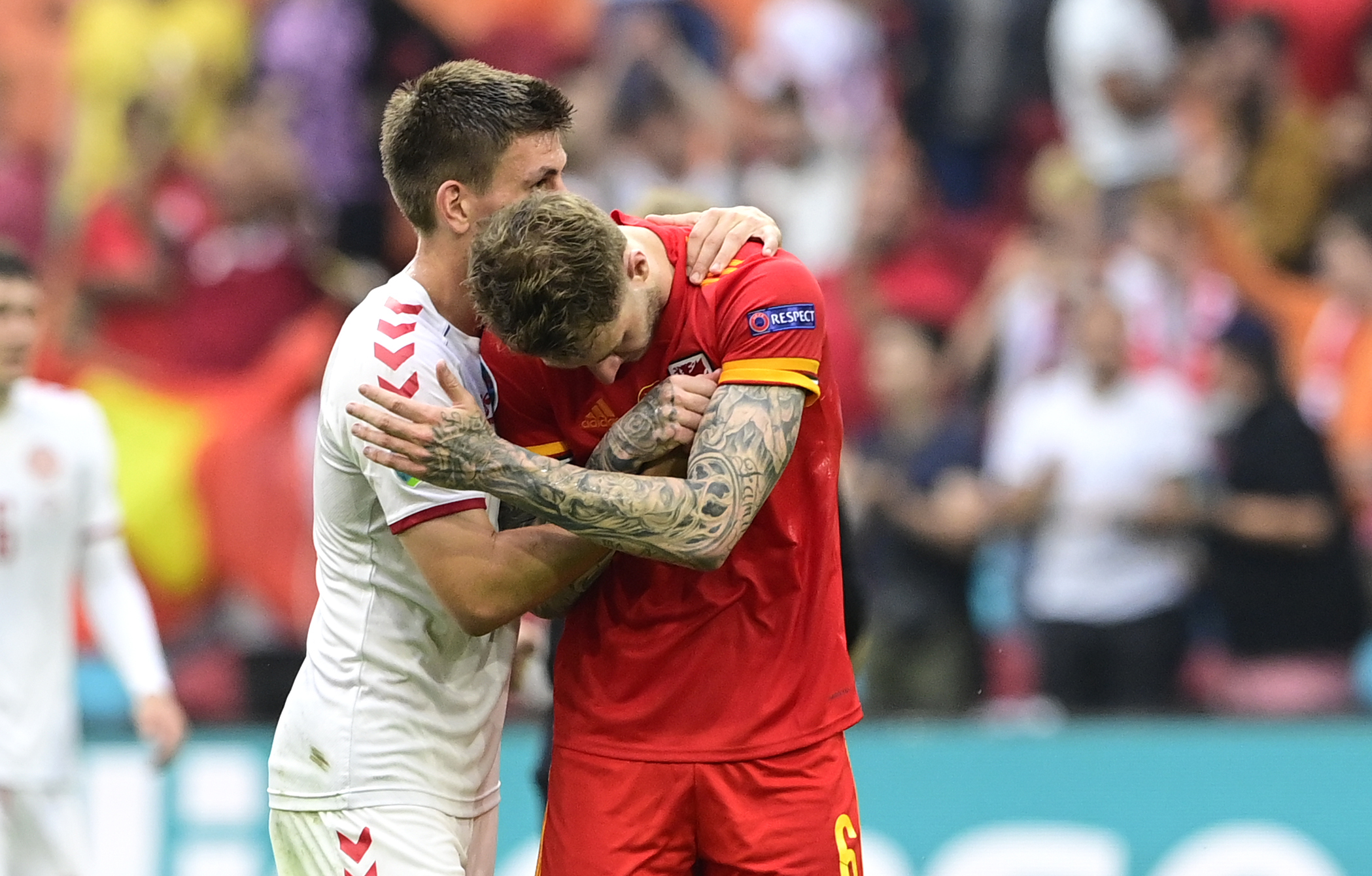 Denmark’s defender Joakim Maehle, left, consoles Wales’ Joe Rodon at the end of their last 16 game