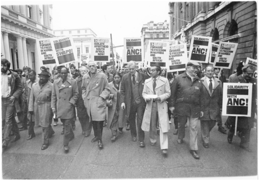 Anwar and Tony Benn (centre) at an anti-apartheid demonstration in Trafalgar Square, 1982 [Photo courtesy of Anwar Ditta]