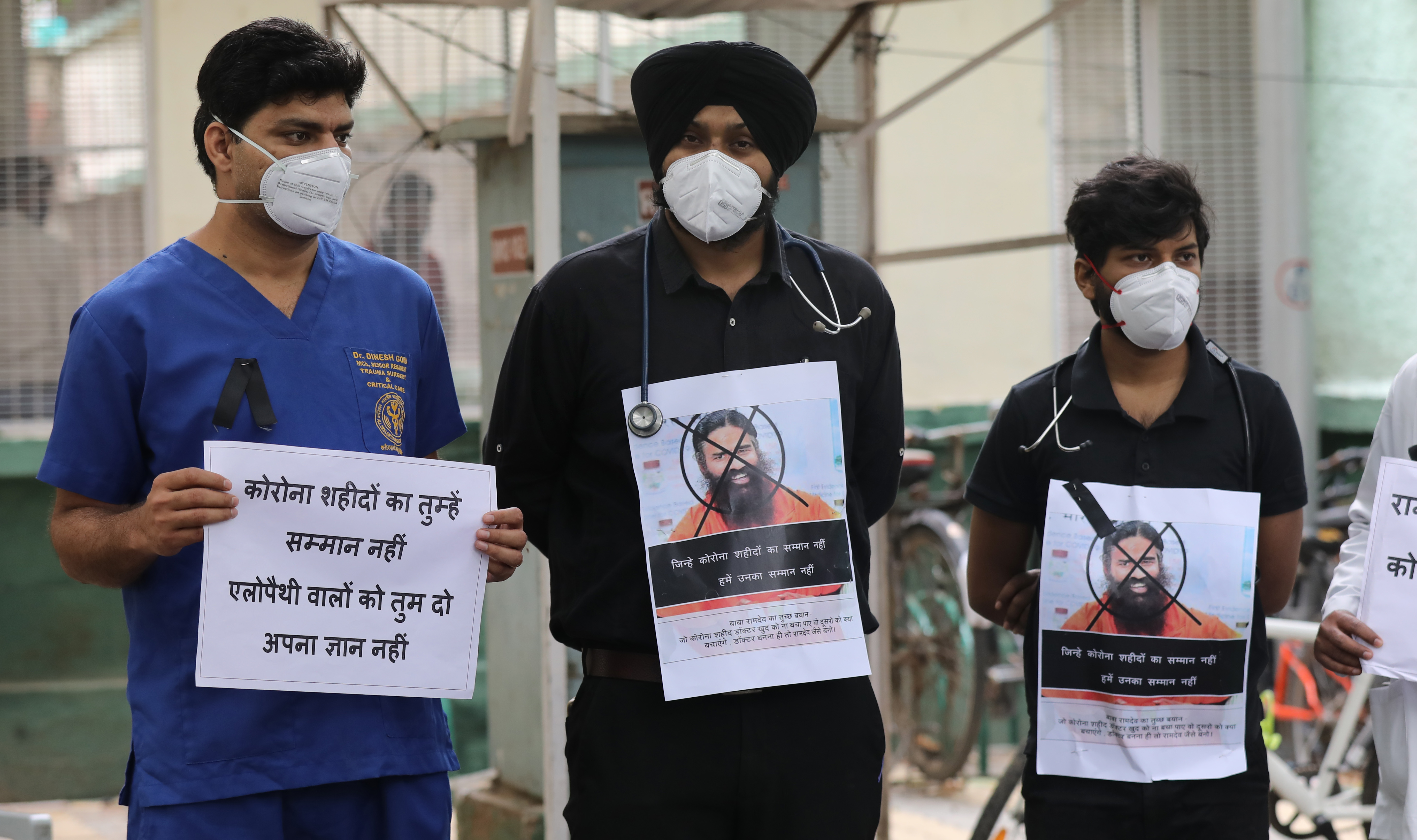 Resident doctors of the AIIMS hold placards as they observe a ‘Black Day’to protest against Ramdev’s remarks