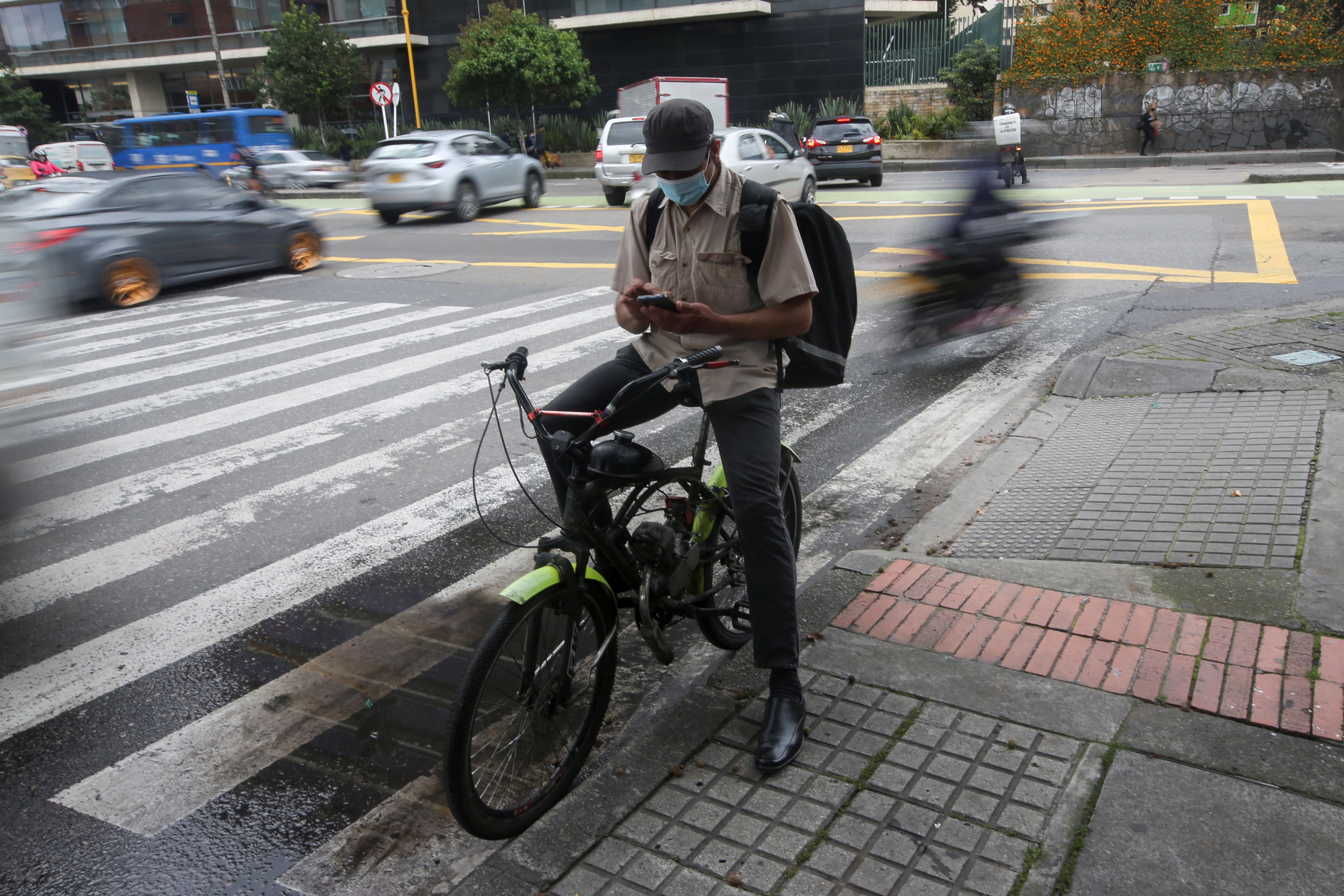 Pablo Toro, Venezuelan delivery worker uses the Valiu app from his cell phone in Bogota, Colombia