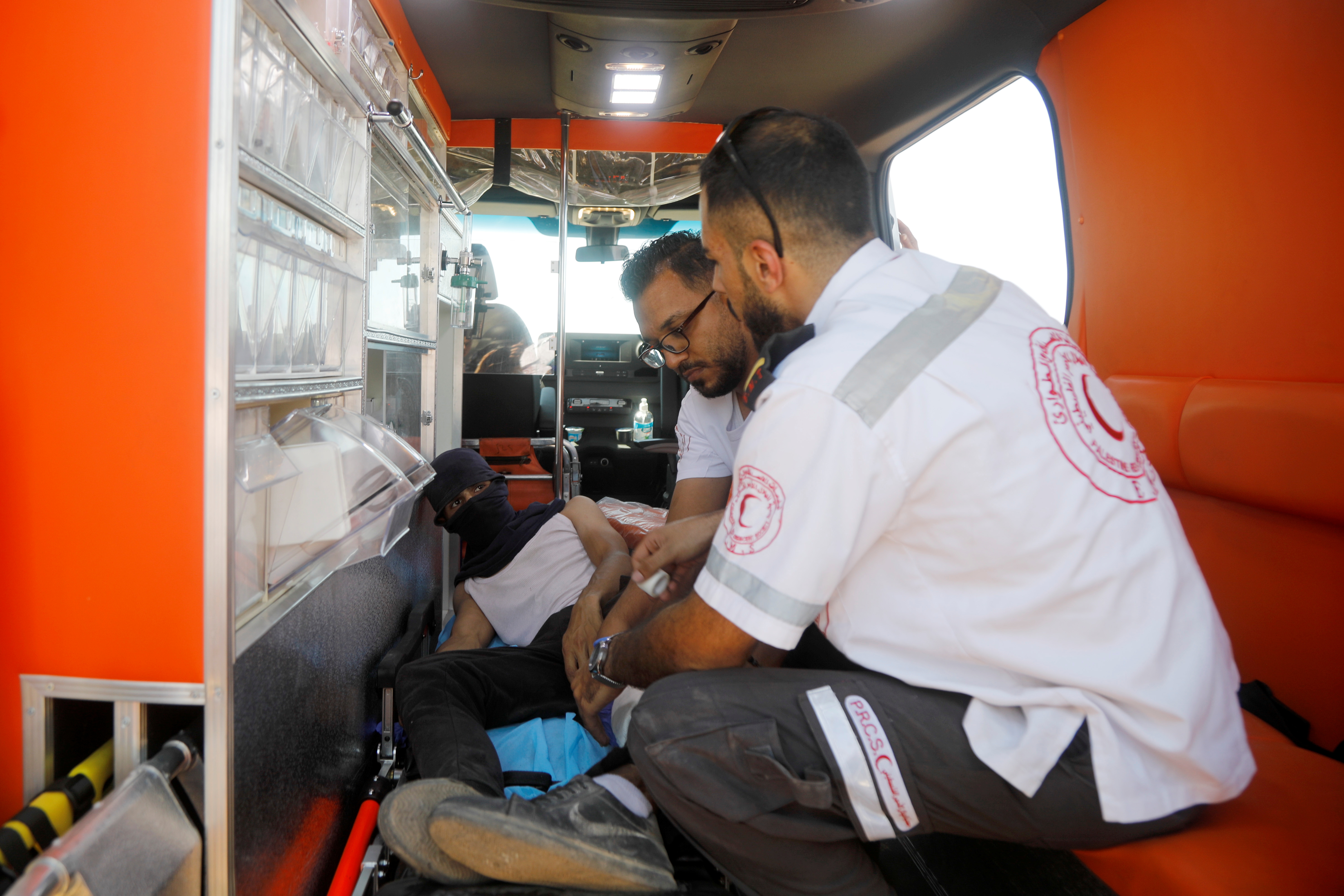 A Palestinian demonstrator gets treatment inside an ambulance following clashes with Israeli forces