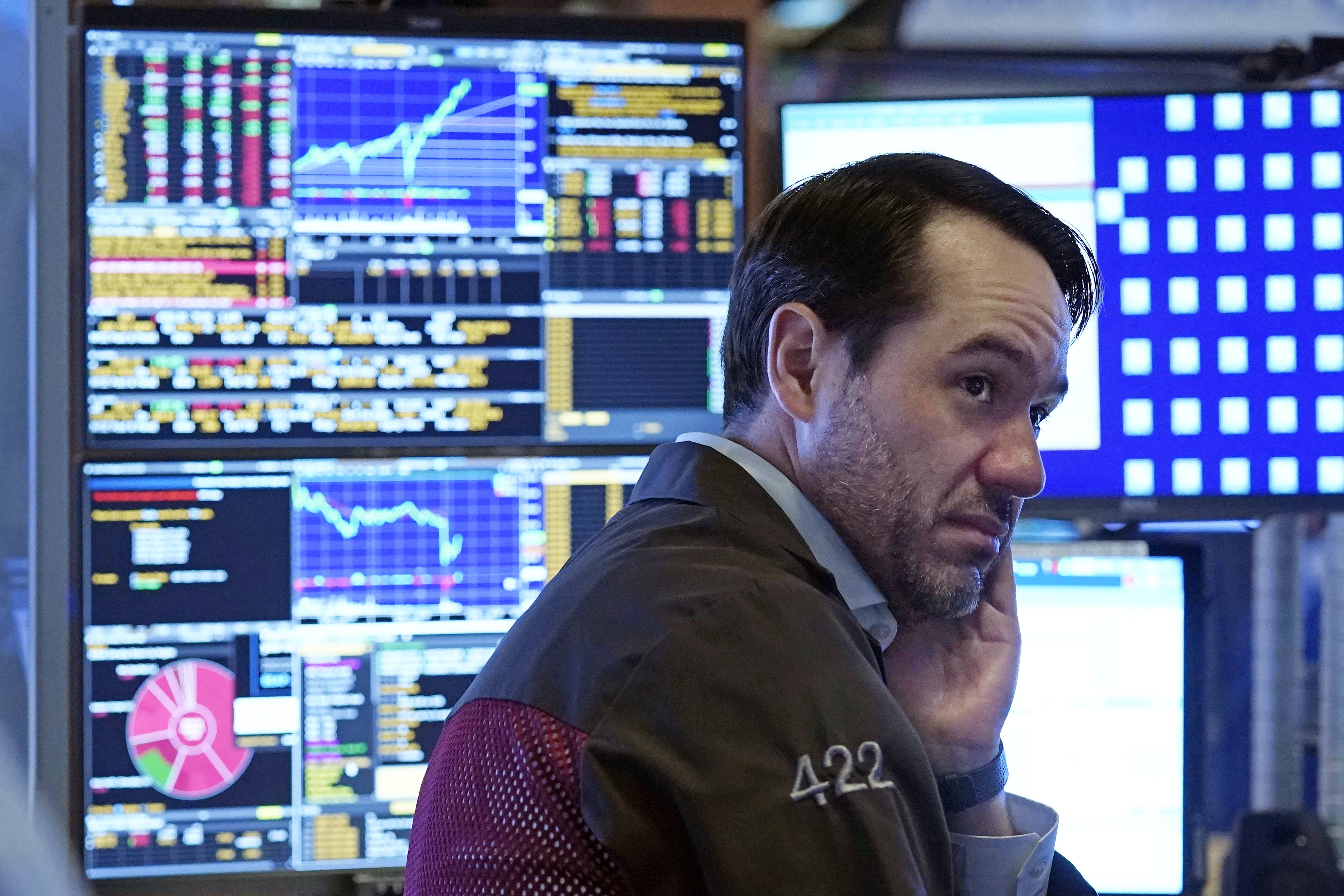 A trader works in a booth on the floor of the New York Stock Exchange