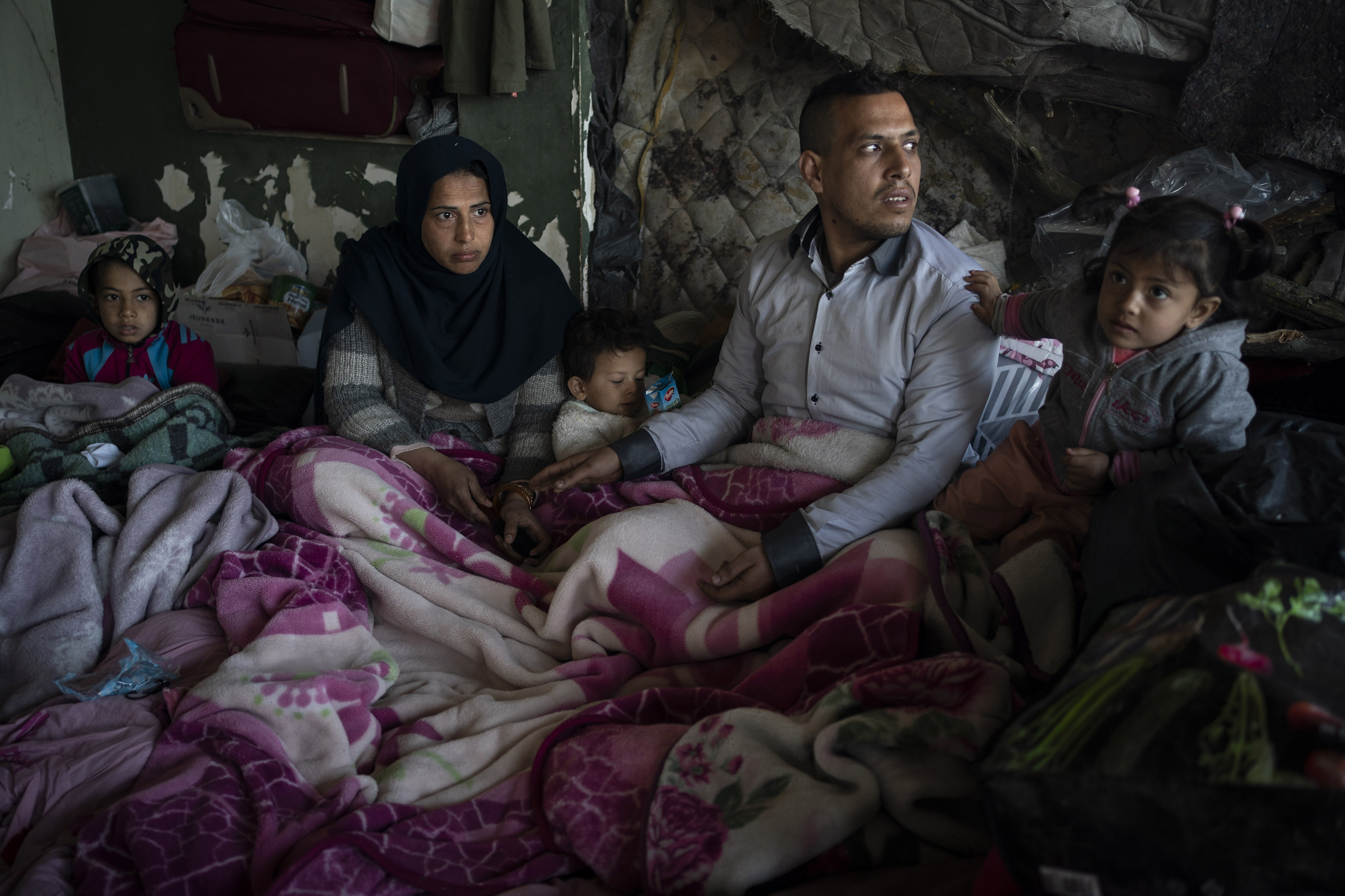 A family from Afghanistan gather at an abandoned building in Edirne, near the Turkish-Greek border on Friday, March 6, 2020