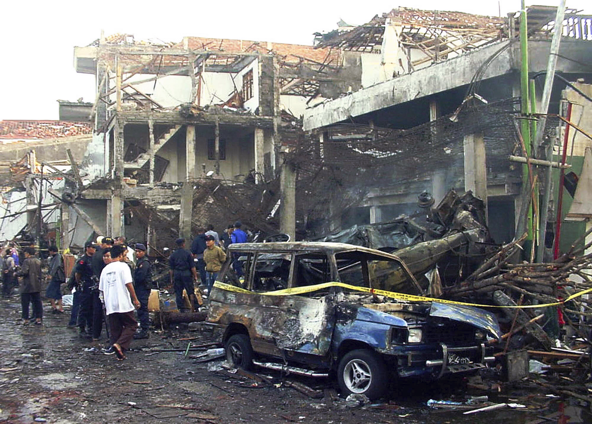 Police officers inspect the ruins of a nightclub destroyed by an explosion in Denpasar, Bali, Indonesia in October 2002