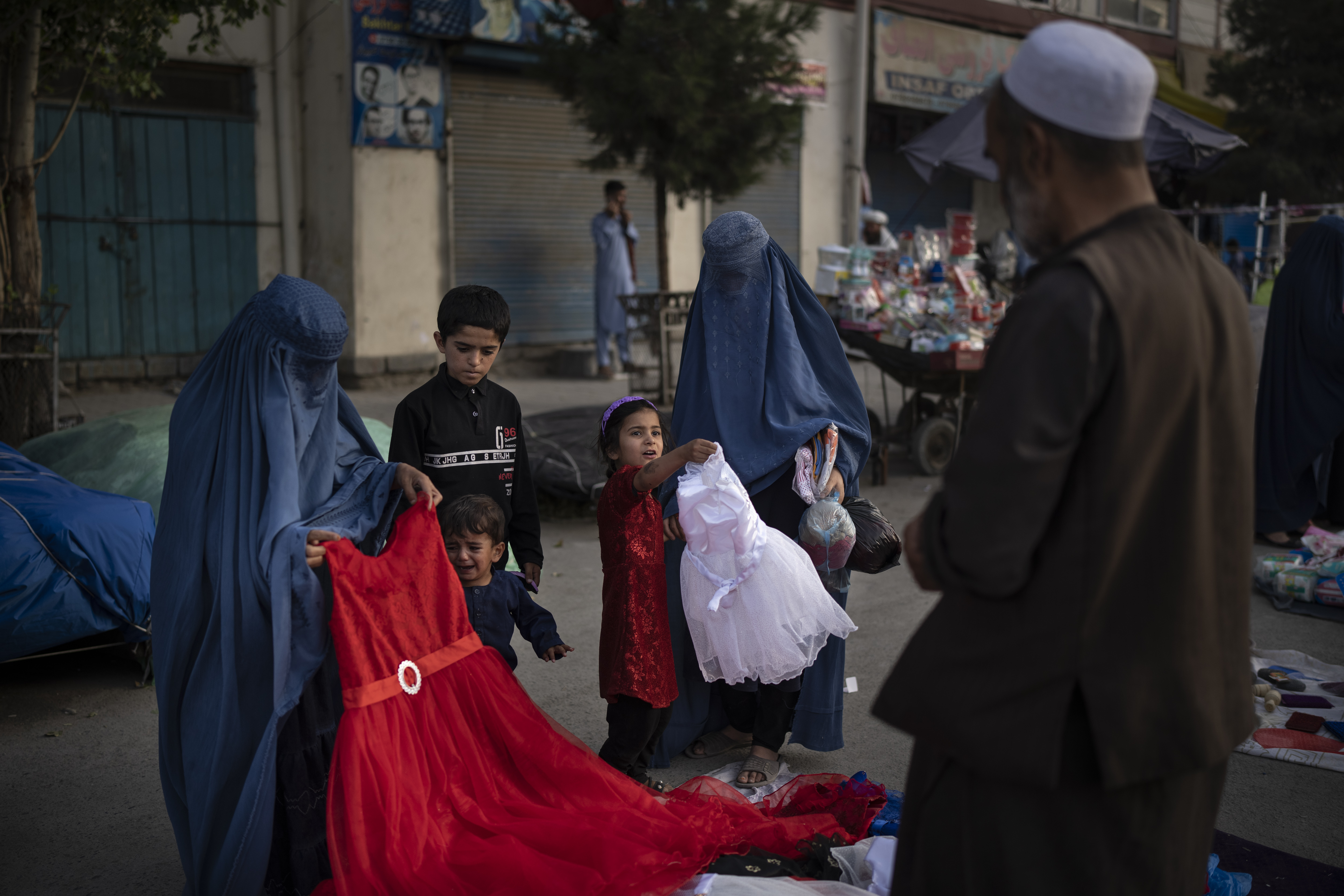 Afghan women shop for dresses at a local market in Kabul