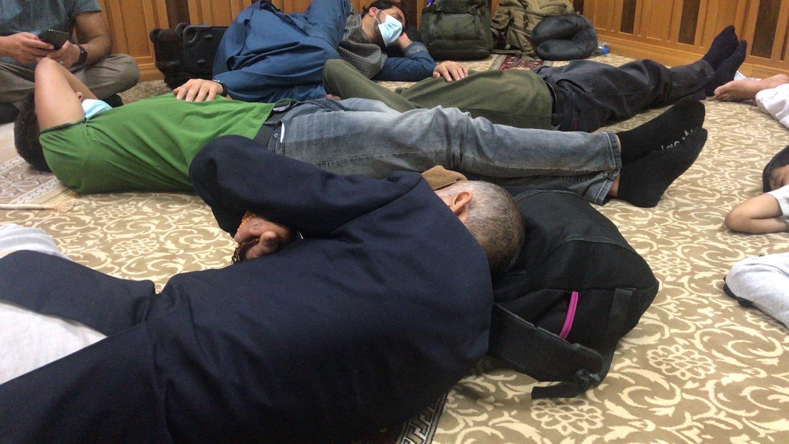 Passengers on a Kam Air flight from Kabul sleep on the floor at Abu Dhabi airport after the plane was denied entry to the United States [Photo provided by Project Dynamo]