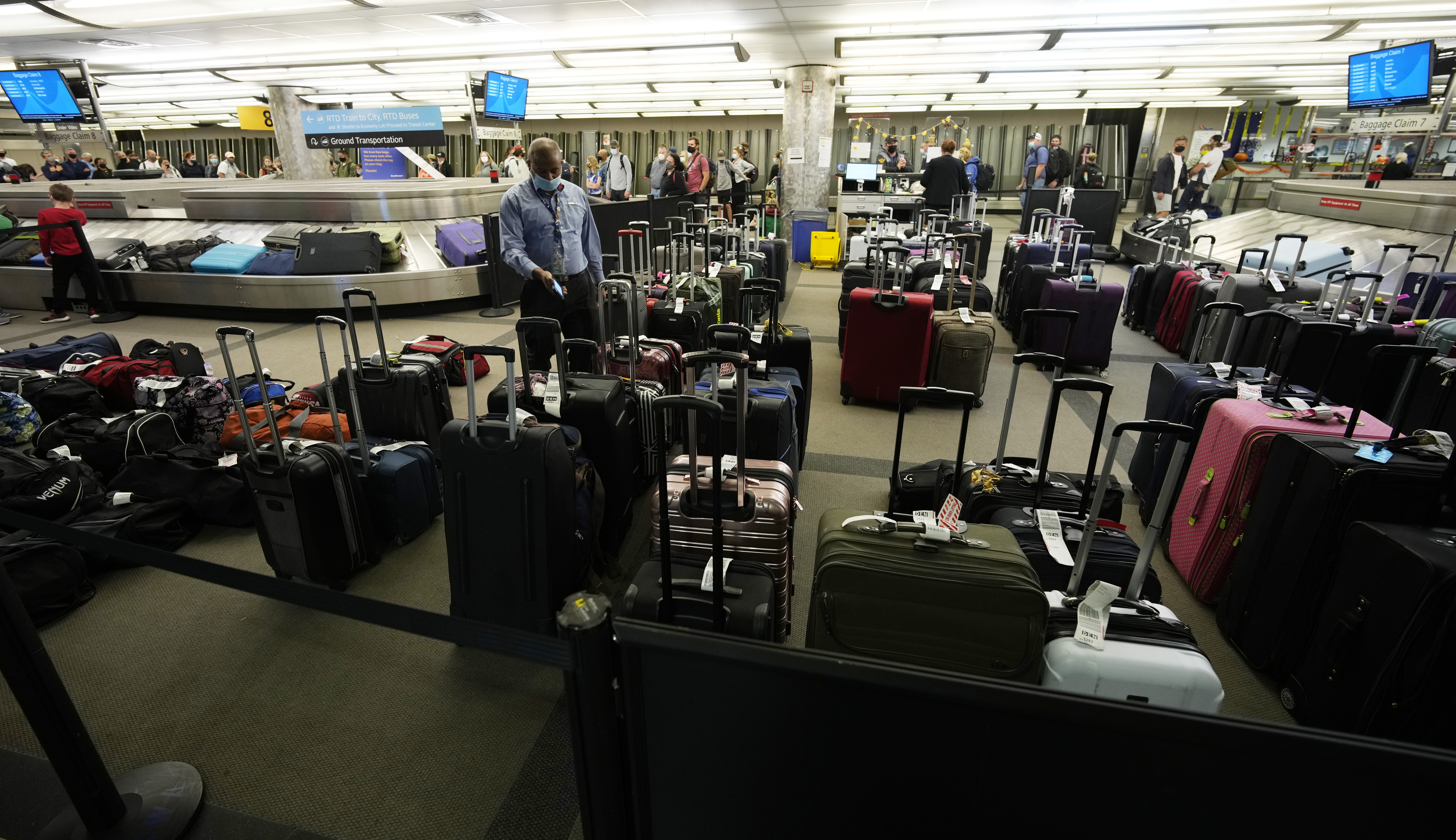 Unclaimed baggage wells up between carousels for passengers arriving on Southwest Airlines flights at Denver International Airport late on Sunday