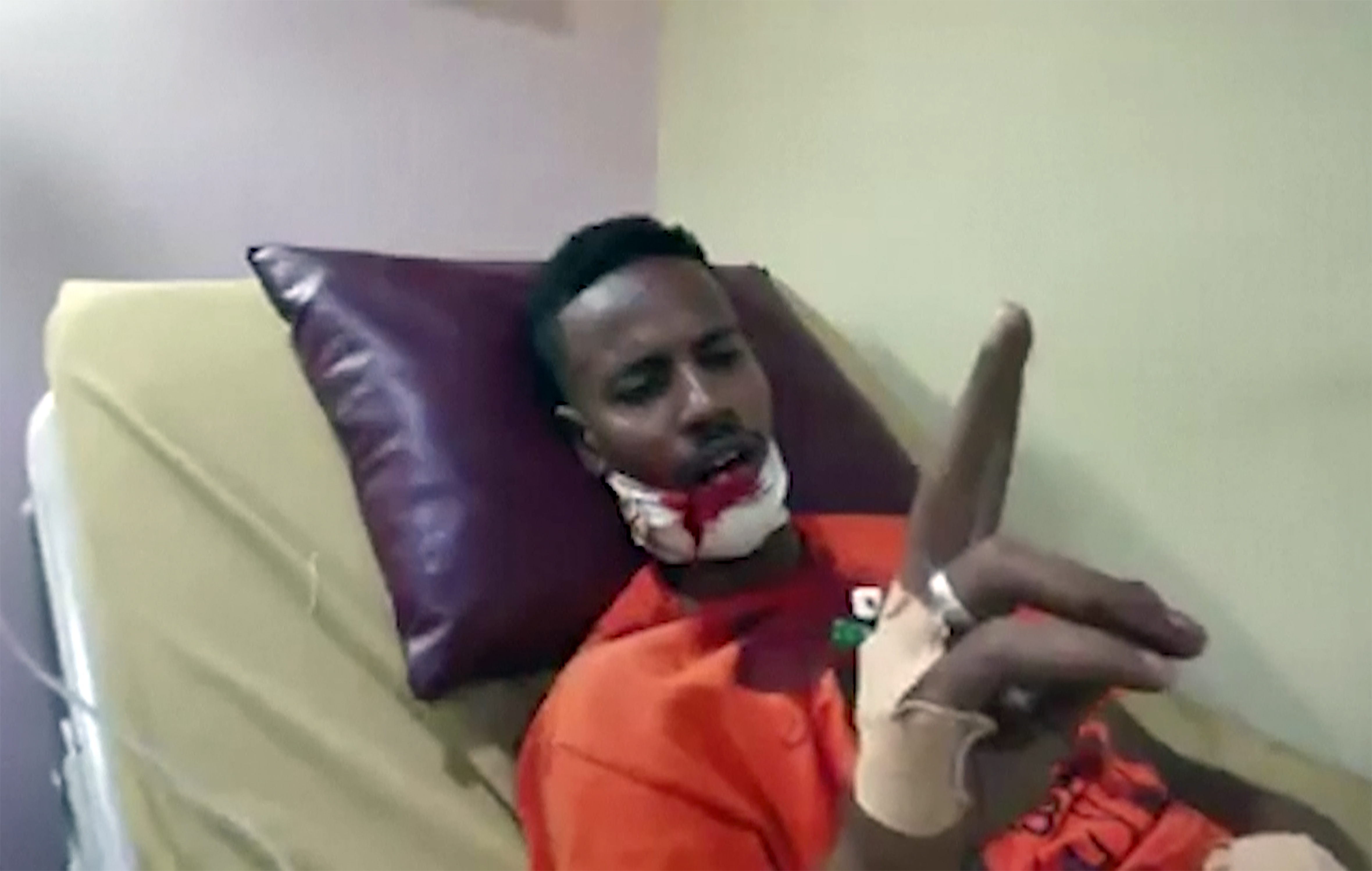 A protester is given medical treatment following mass demonstrations a day after the military seized power [AP]