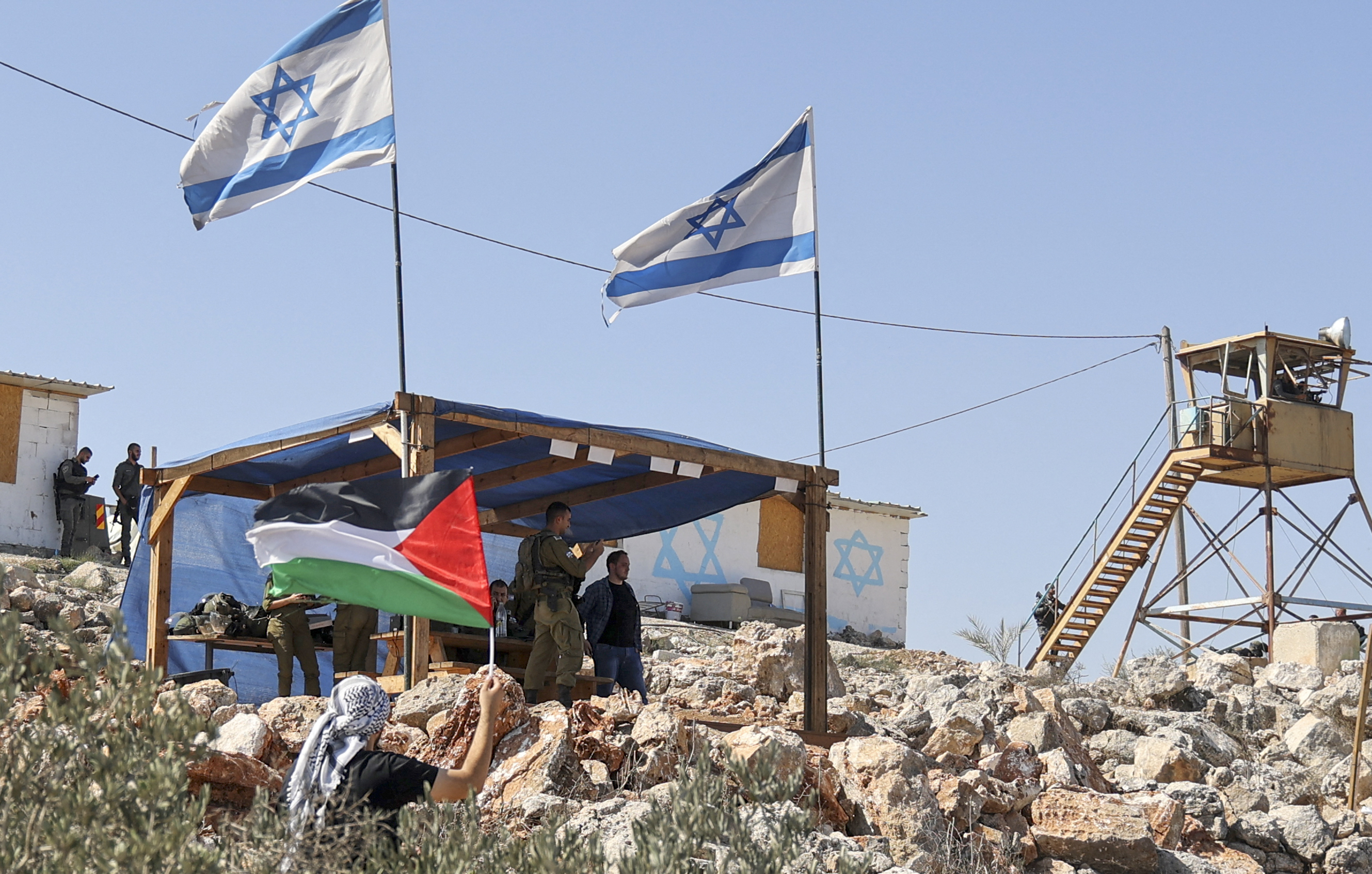 The brothers were fixing a tire after their vehicle broke down before Israeli settler ran them over, local media said.