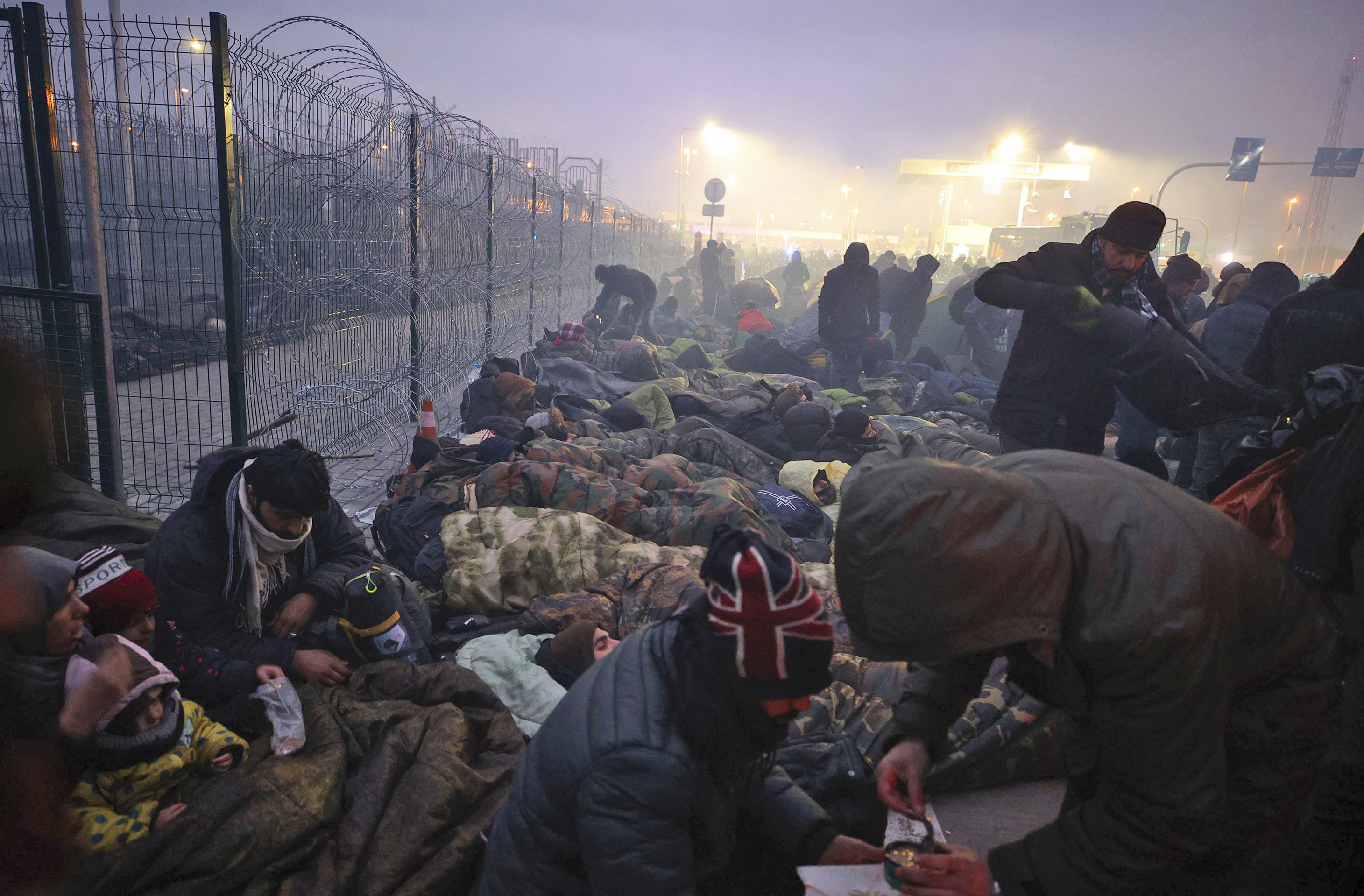 Migrants from the Middle East and elsewhere gather at the Belarus-Poland border