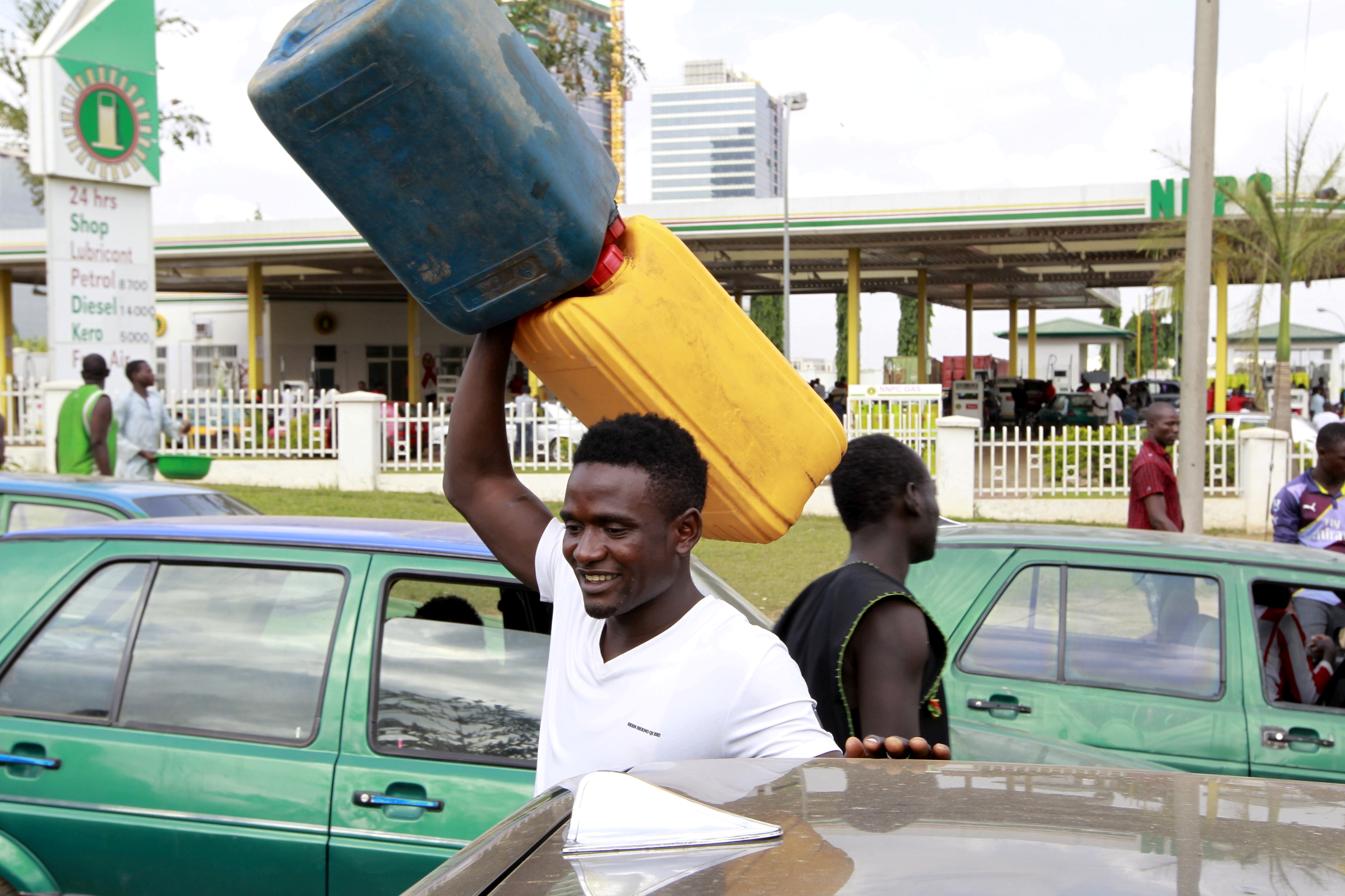 A man carries empty petrol containers outside the NNPC mega petrol station in Abuja, Nigeria on May 25, 2015