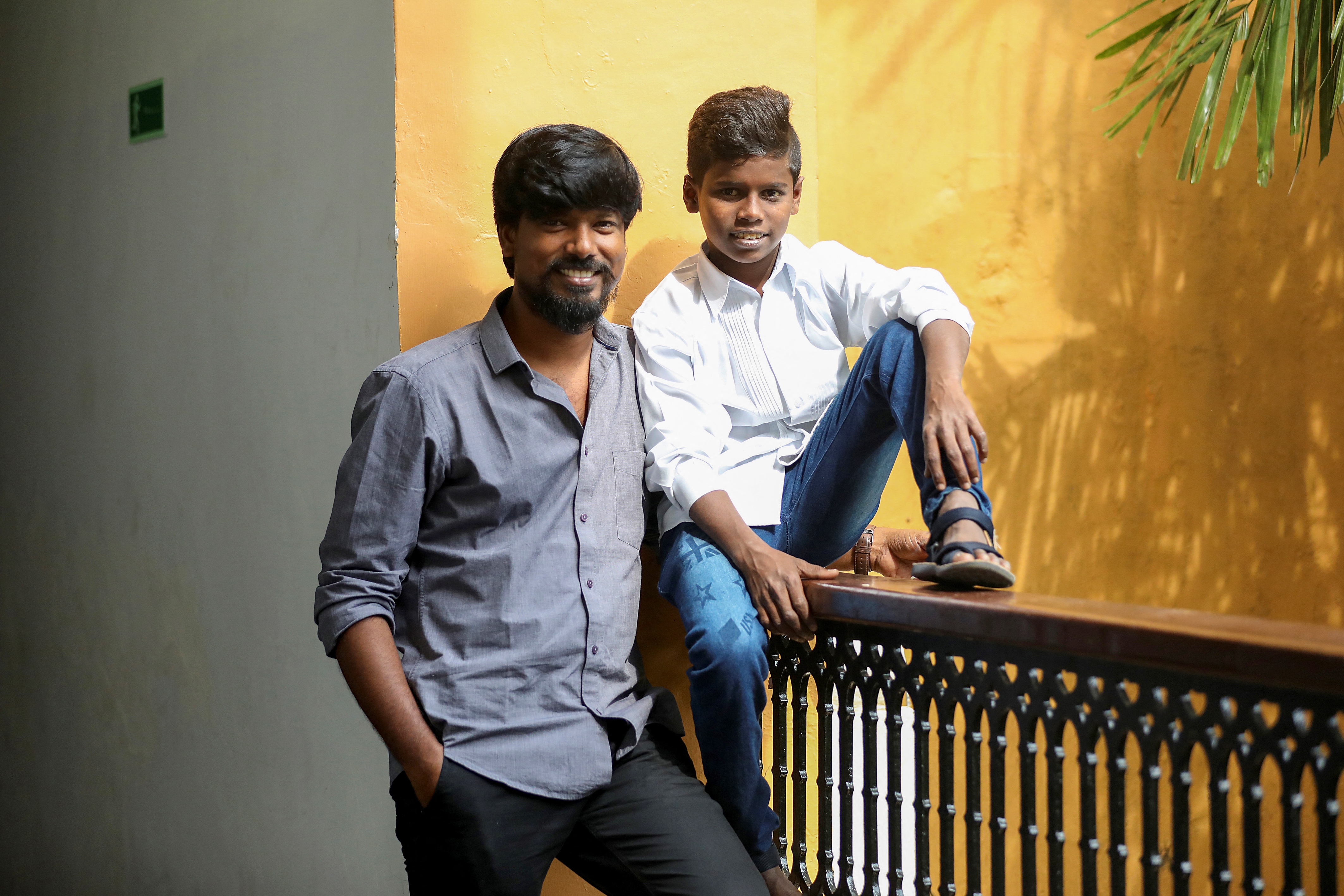 Vinothraj, (left), poses with actor Chellappandi during the 52nd International Film Festival of India in Goa [AFP]