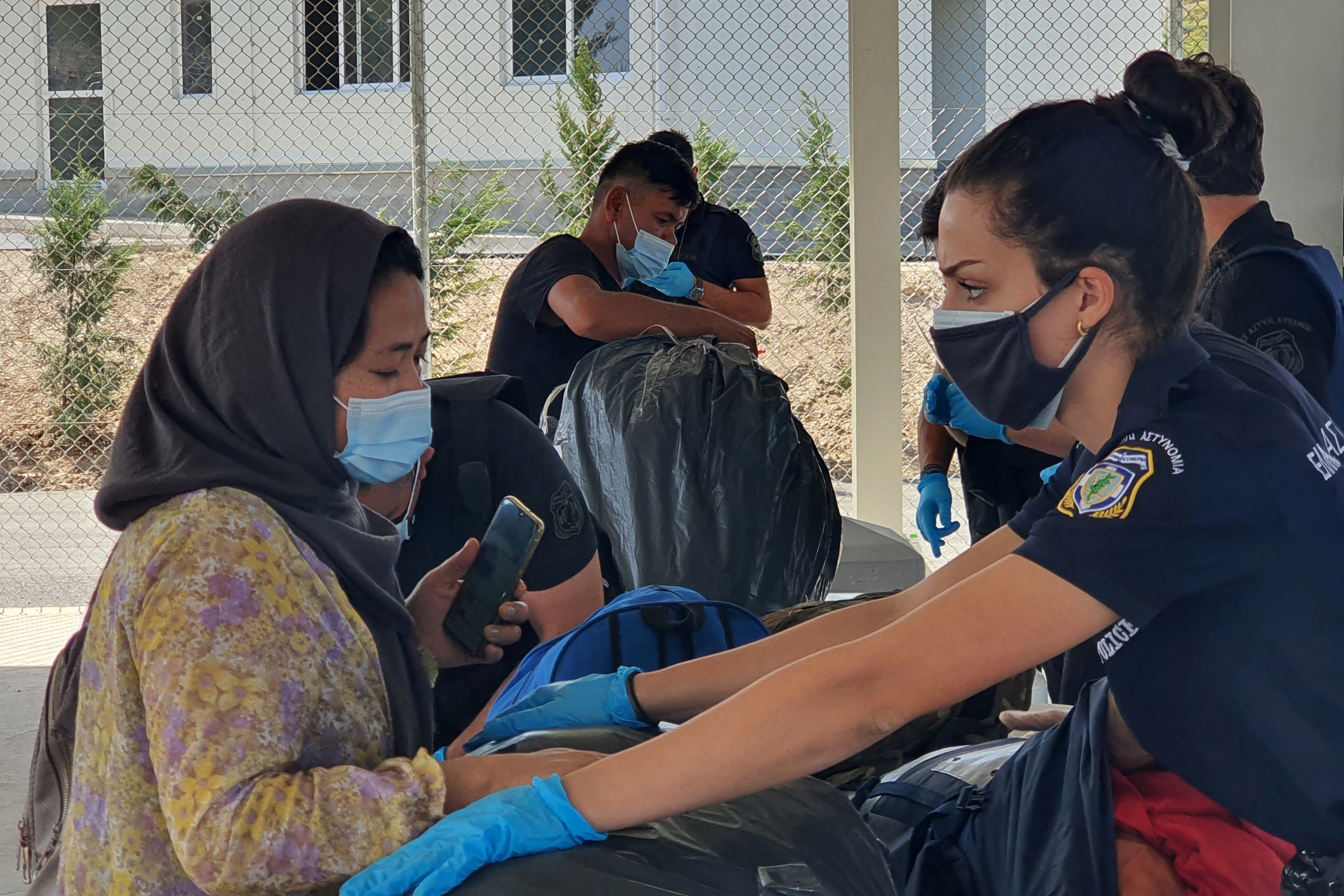 Police check refugees at Refugee camp Samos, Greece