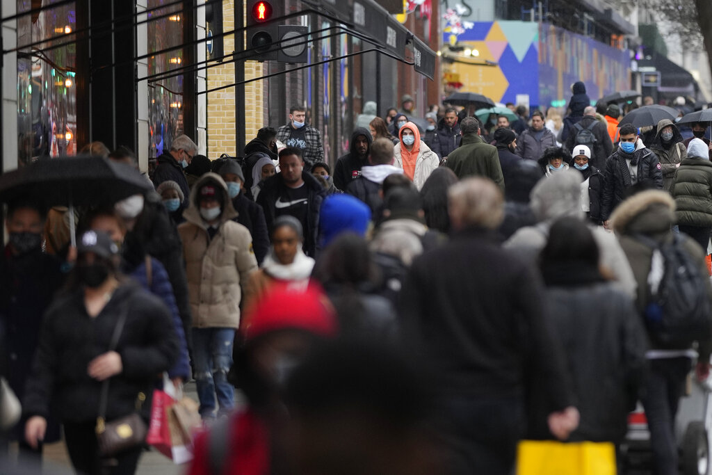 Shoppers wear face masks on Oxford Street in London on December 24.