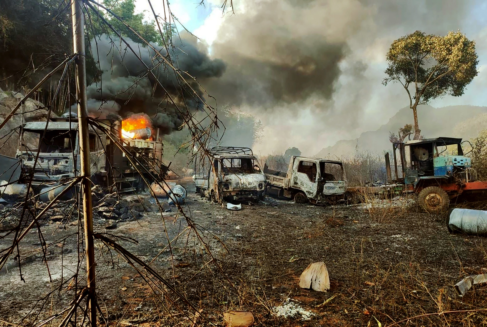 Smoke and flames billow from vehicles set alight in Hpruso township. Dozens of civilians were killed in the attack