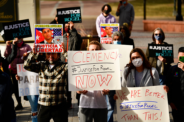 People hold signs in support of truck driver Rogel Aguilera-Mederos