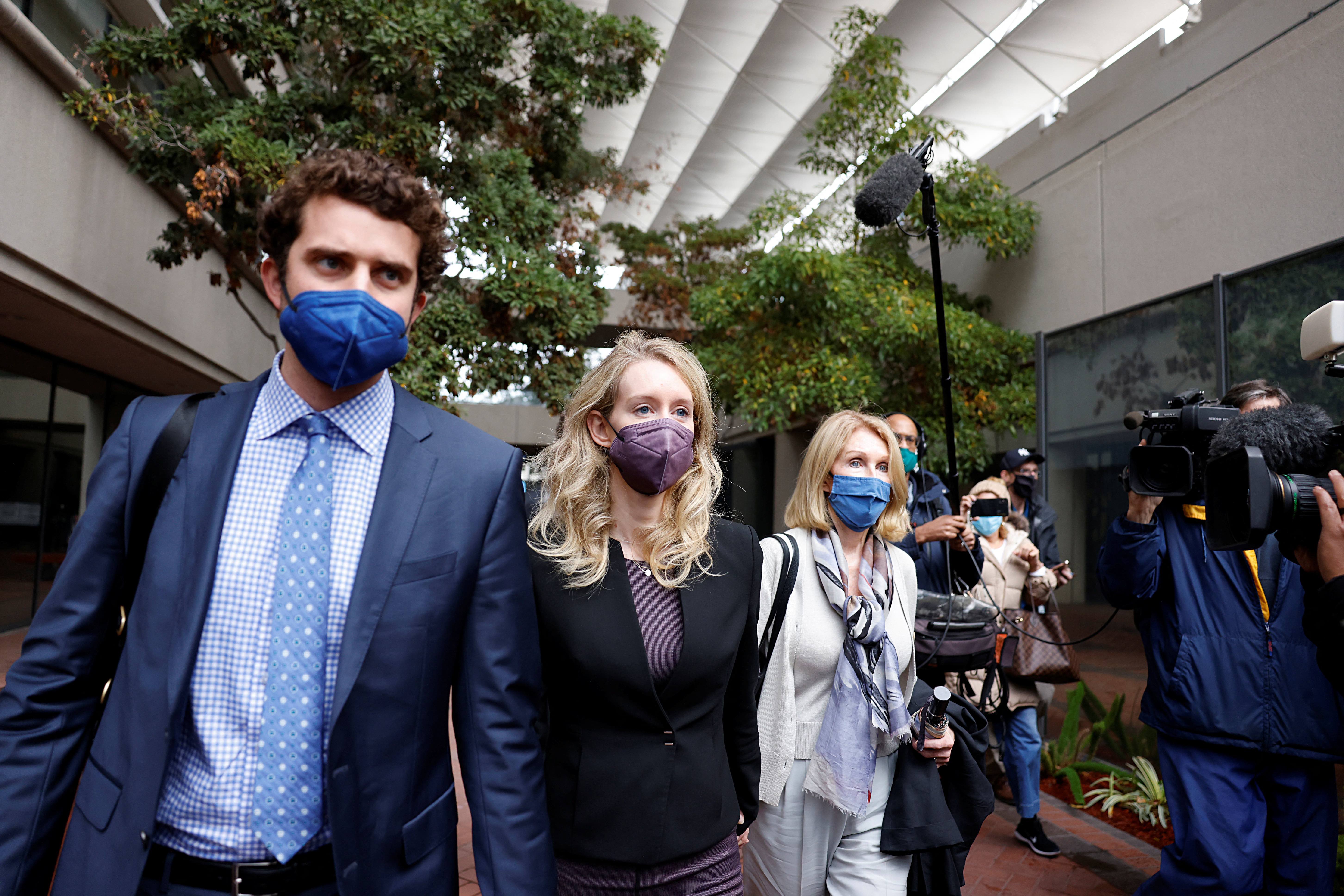 Theranos founder Elizabeth Holmes departs the court with her partner Billy Evans and her mother Noel Holmes
