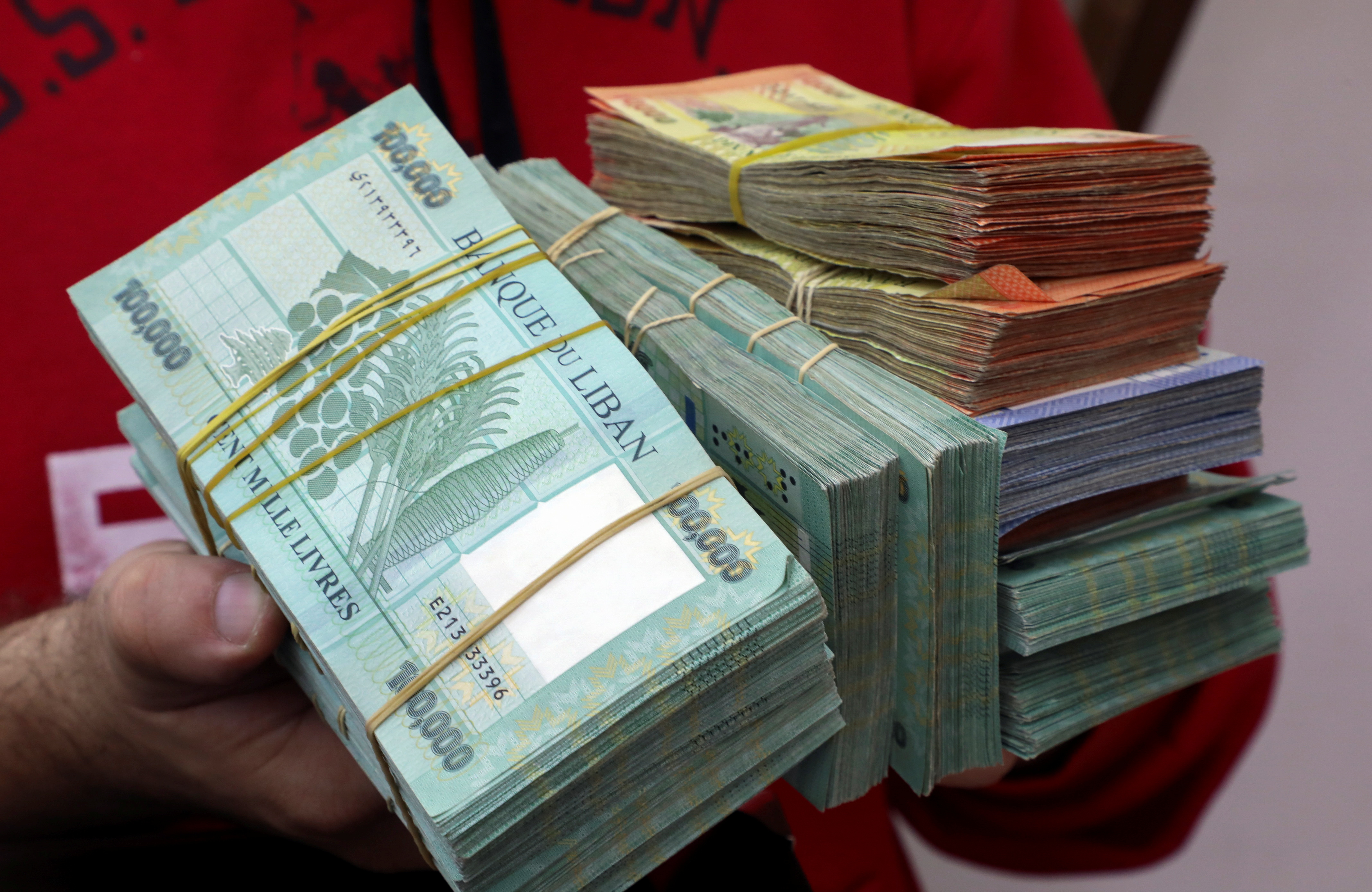 A money exchange vendor displays Lebanese pound banknotes at his shop in Beirut, Lebanon,