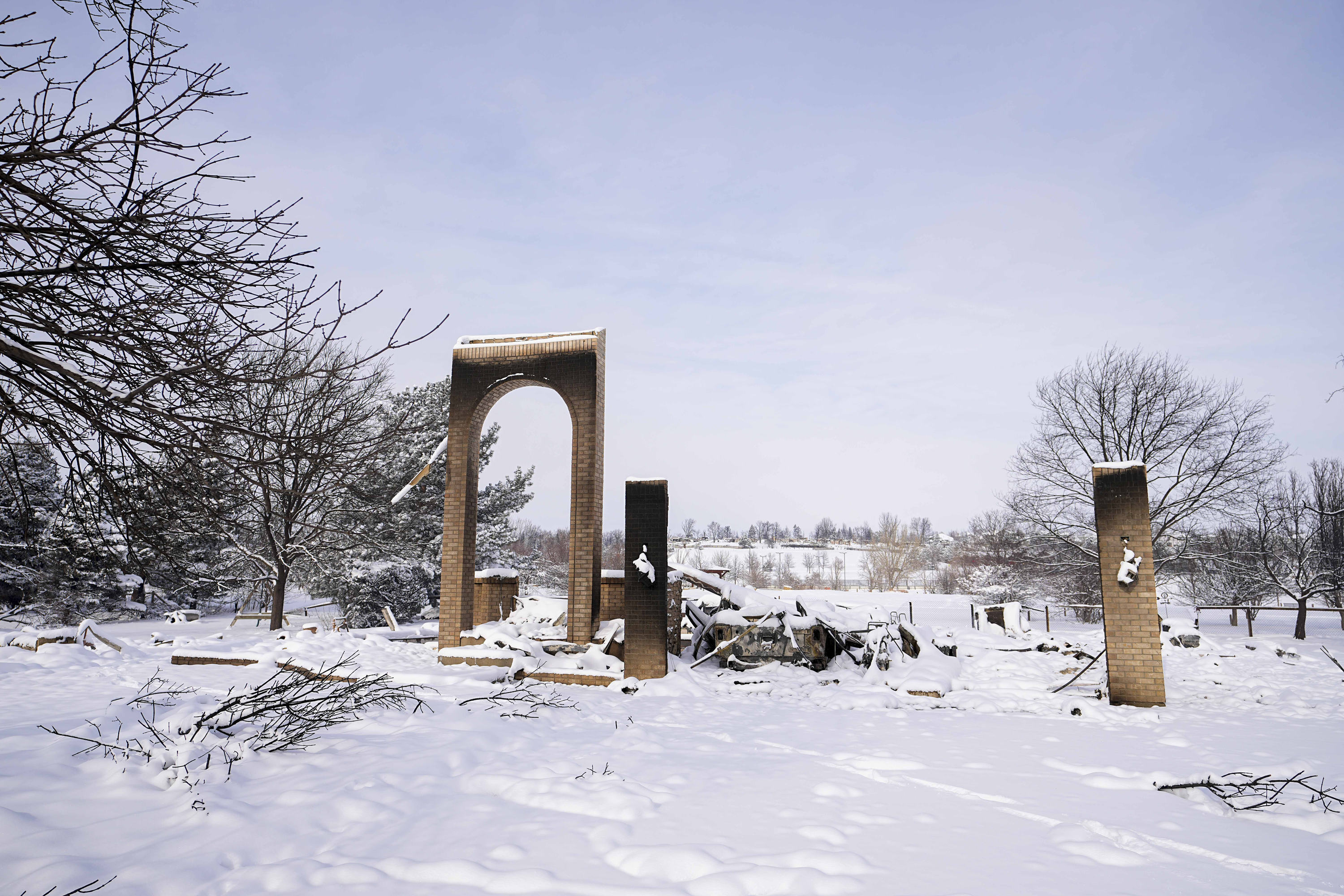 Snow covers the burned remains of homes after the Marshall Wildfire in Colorado